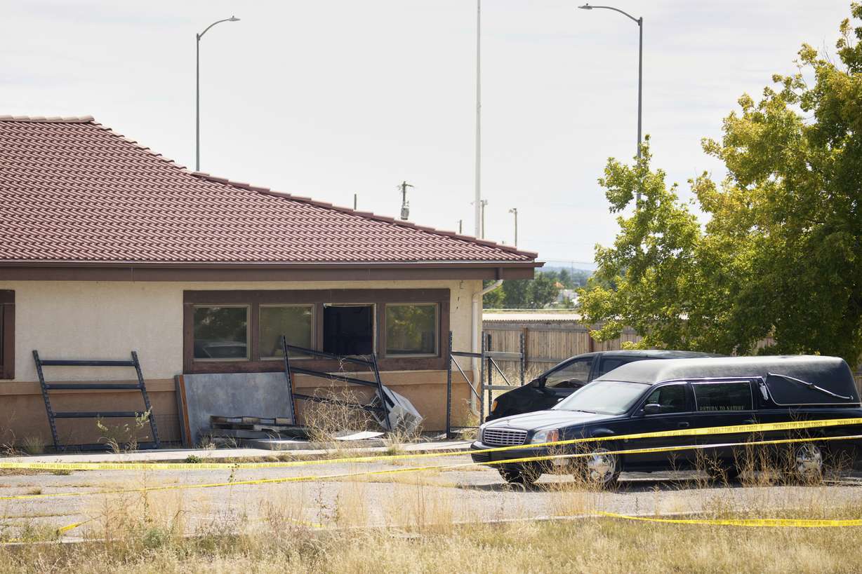A hearse and van sit outside the Return to Nature Funeral Home in Penrose, Colo., on Oct. 6, 2023.