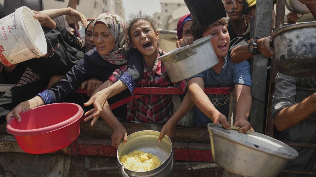 Palestinians struggle to get donated food at a community kitchen in Gaza City, northern Gaza Strip on Aug. 16. The world's leading authority on food crises says the Gaza Strip's largest city is gripped by famine.