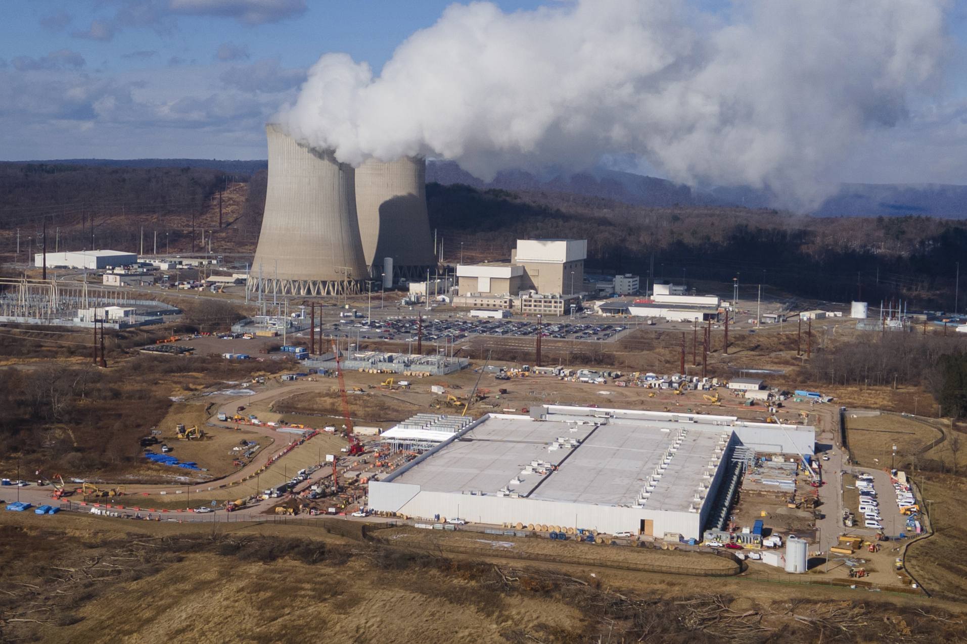 A data center owned by Amazon Web Services, front right, is under construction next to the Susquehanna nuclear power plant in Berwick, Pa., on January 14. 