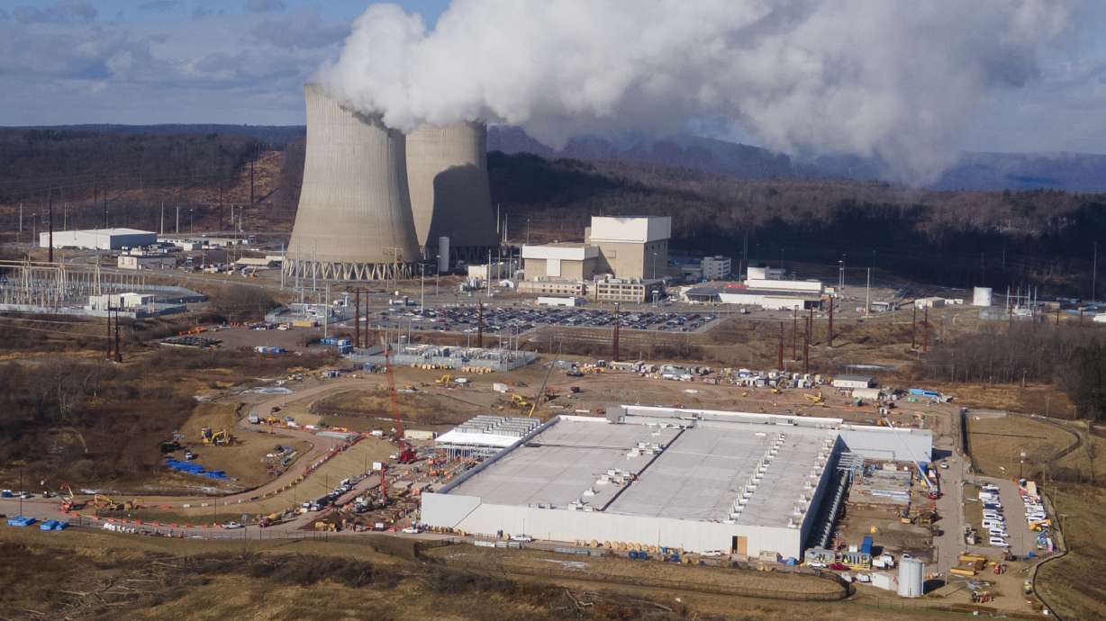 A data center owned by Amazon Web Services, front right, is under construction next to the Susquehanna nuclear power plant in Berwick, Pa., on January 14.