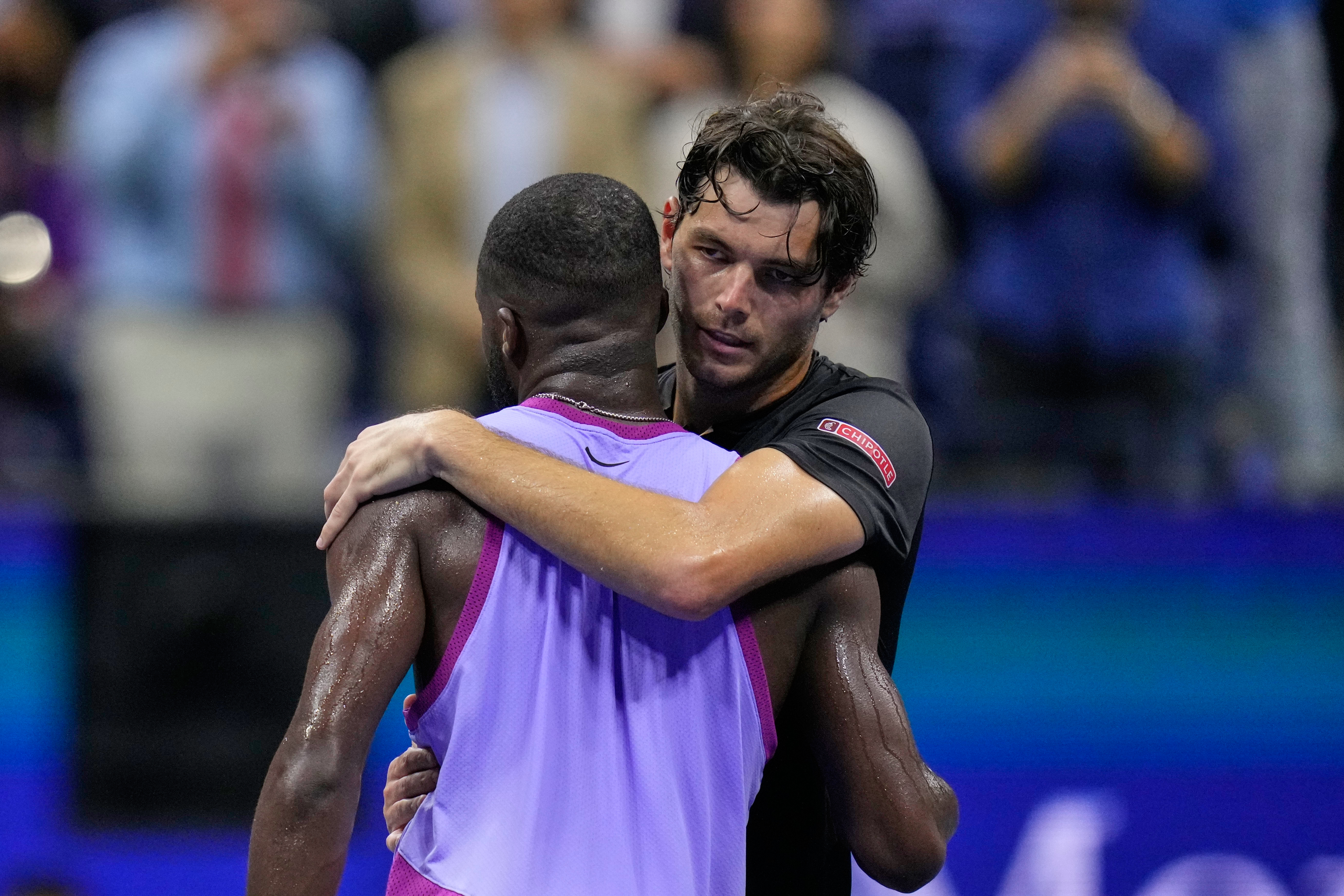 FILE - Taylor Fritz, of the United States, hugs Frances Tiafoe, of the United States, after winning the men's singles semifinals of the U.S. Open tennis championships, Sept. 6, 2024, in New York. 