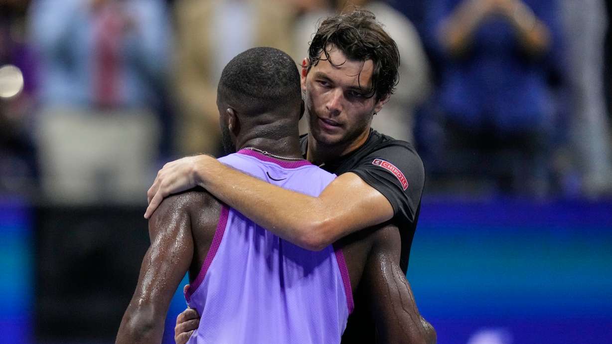 FILE - Taylor Fritz, of the United States, hugs Frances Tiafoe, of the United States, after winning the men's singles semifinals of the U.S. Open tennis championships, Sept. 6, 2024, in New York.