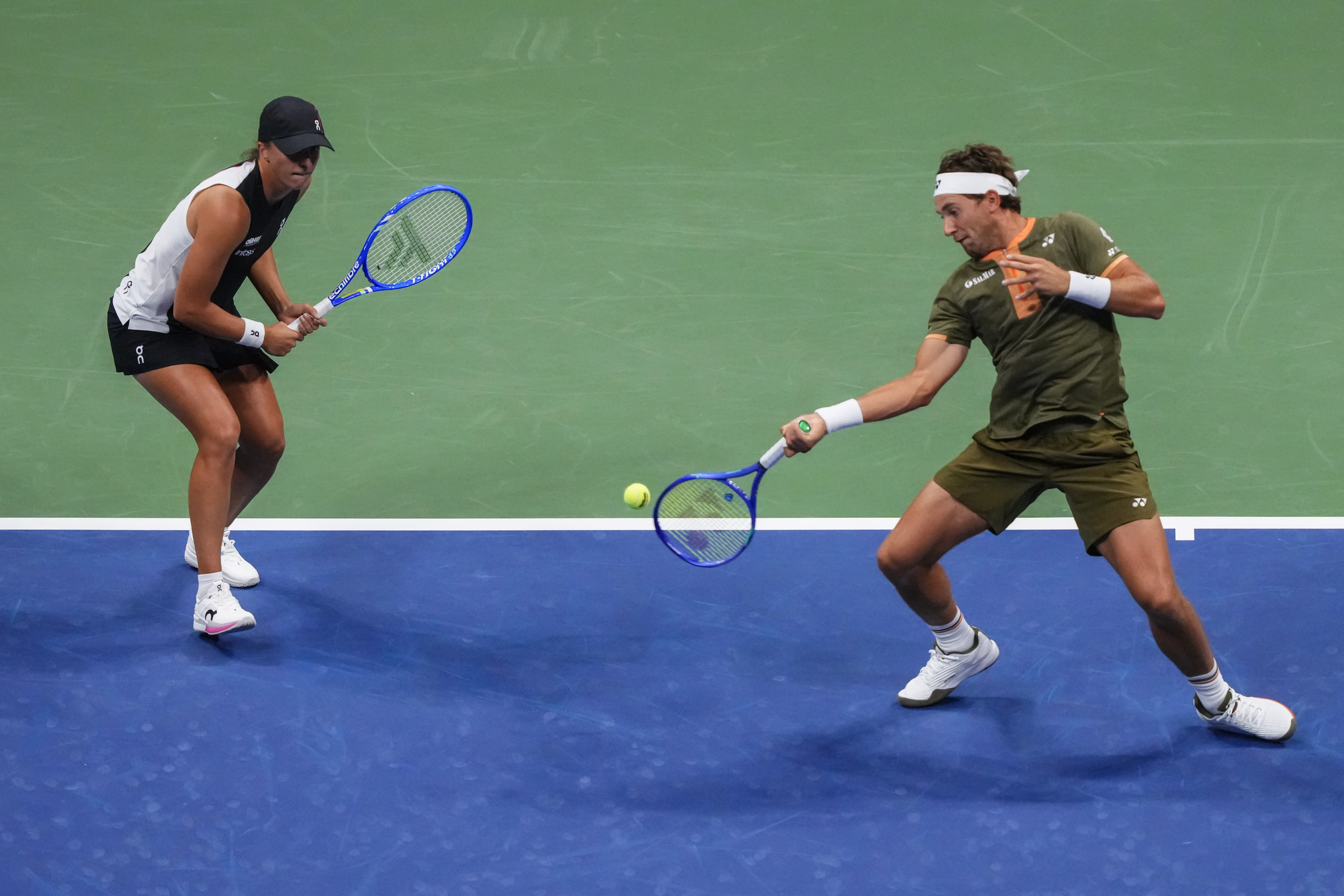 Casper Ruud, right, of Norway, plays with Iga Swiatek, left, of Poland, during the mixed doubles final at the U.S. Open tennis championships, Wednesday, Aug. 20, 2025, in New York. 