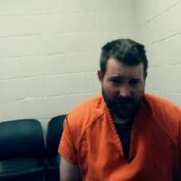 Man accused of killing 2 police officers sobs during first court appearance