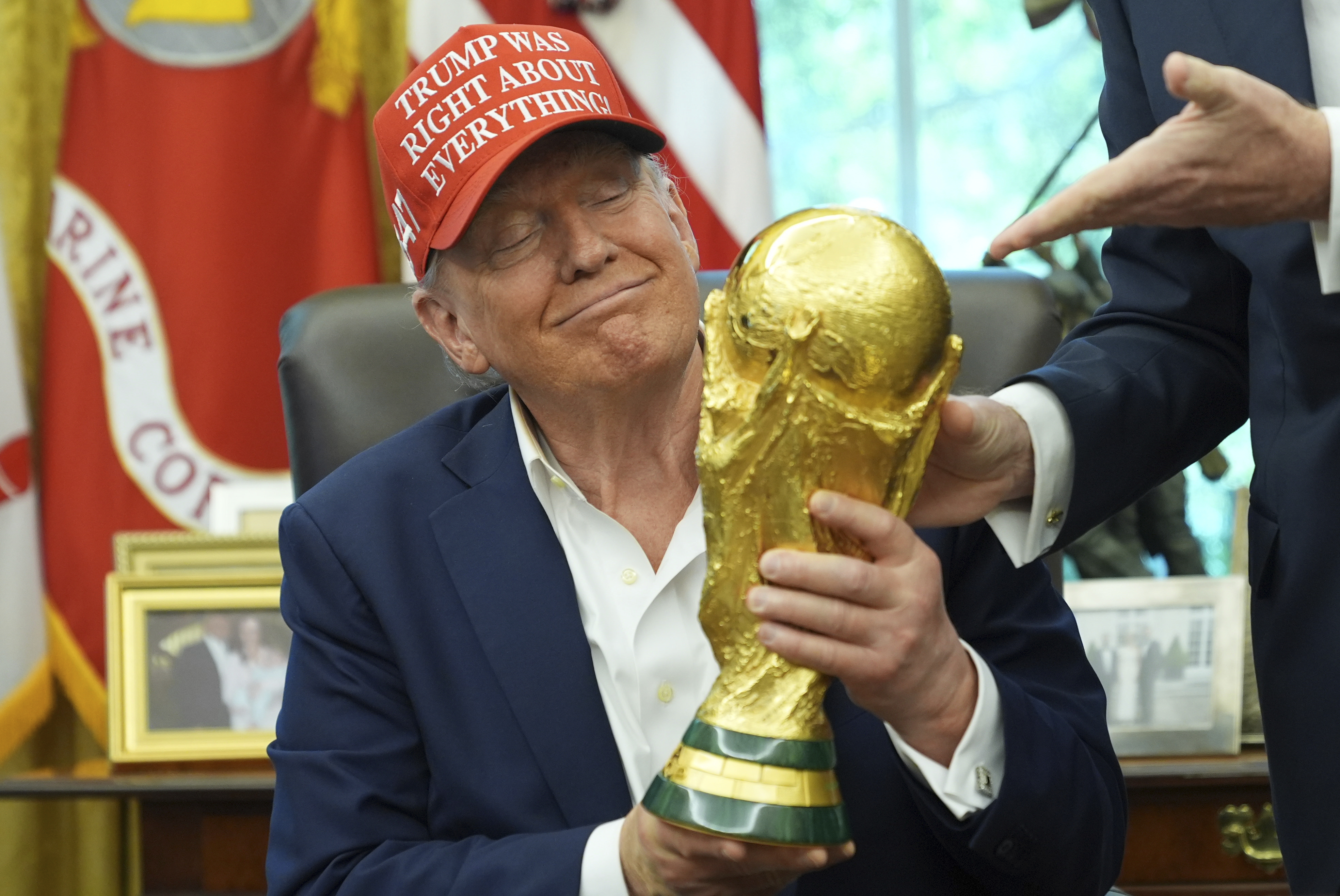 President Donald Trump holds the FIFA World Cup Winners Trophy during an announcement in the Oval Office of the White House, Friday, Aug. 22, 2025, in Washington.