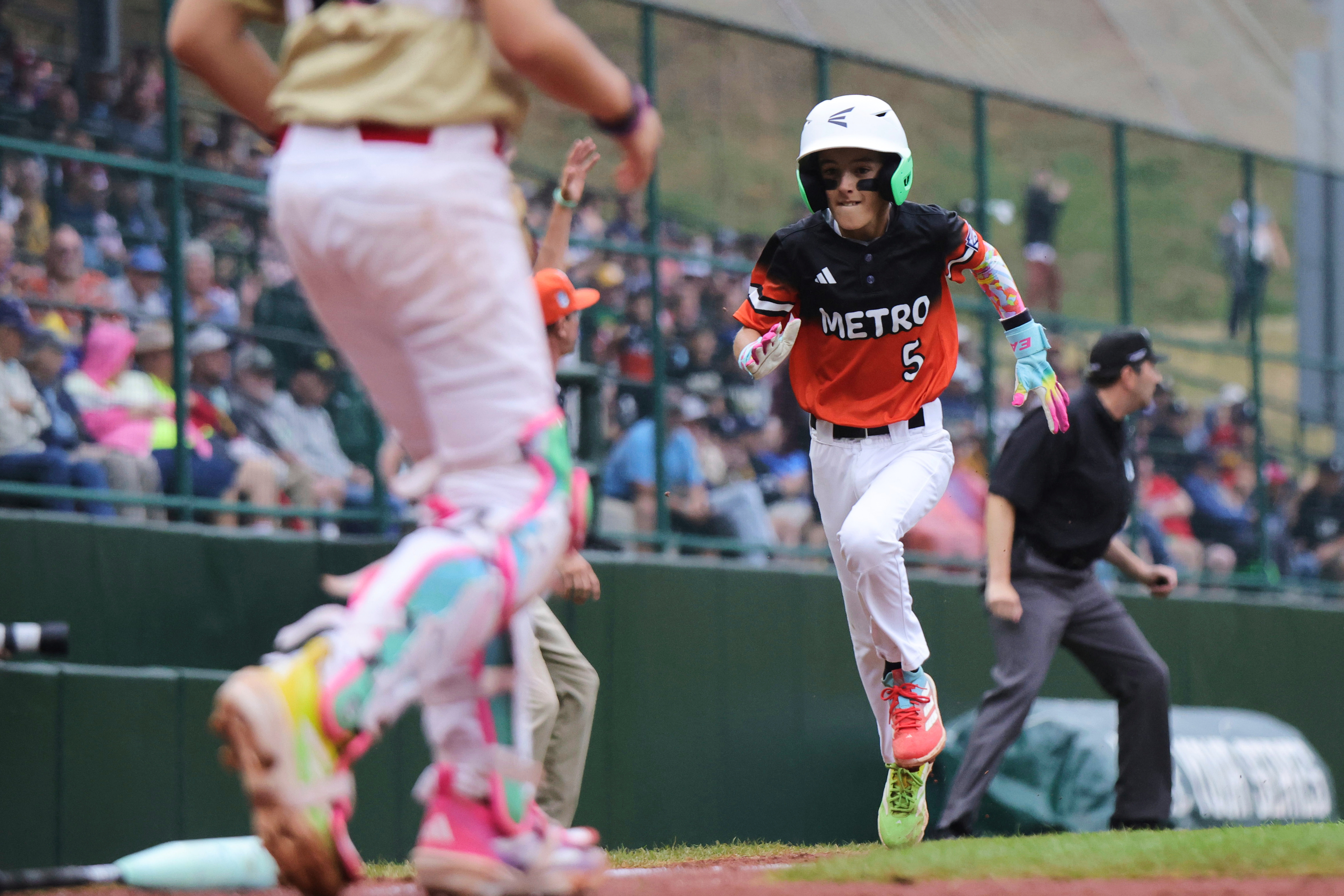 Fairfield, Conn.'s Charlie McCullough scores against Las Vegas, Nev., during the third inning of a baseball game at the Little League World Series, Wednesday, Aug. 20, 2025, in South Williamsport, Pa.