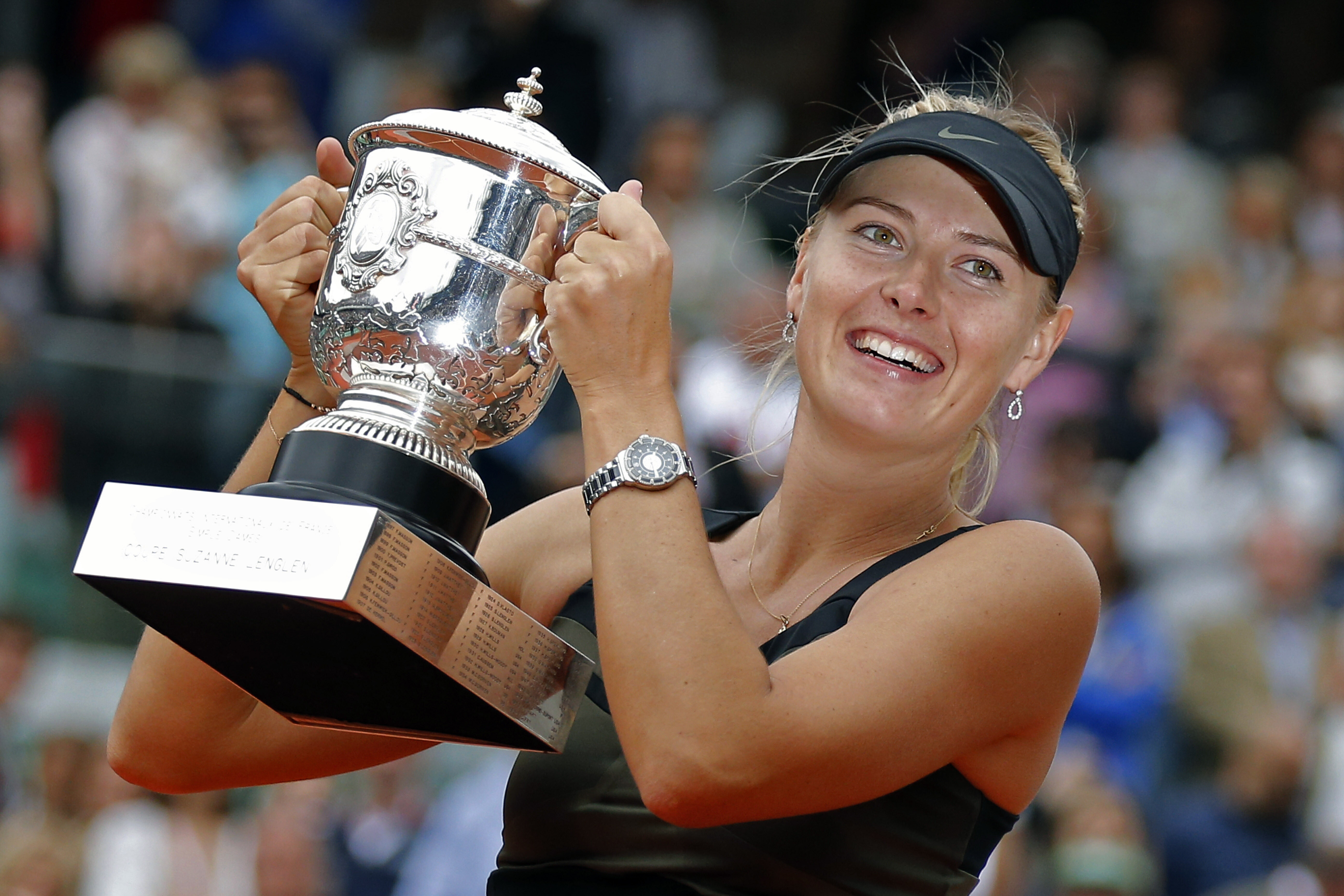 FILE - Maria Sharapova of Russia holds the trophy after winning the women's final match against Sara Errani of Italy at the French Open tennis tournament in Roland Garros stadium in Paris, June 9, 2012. 