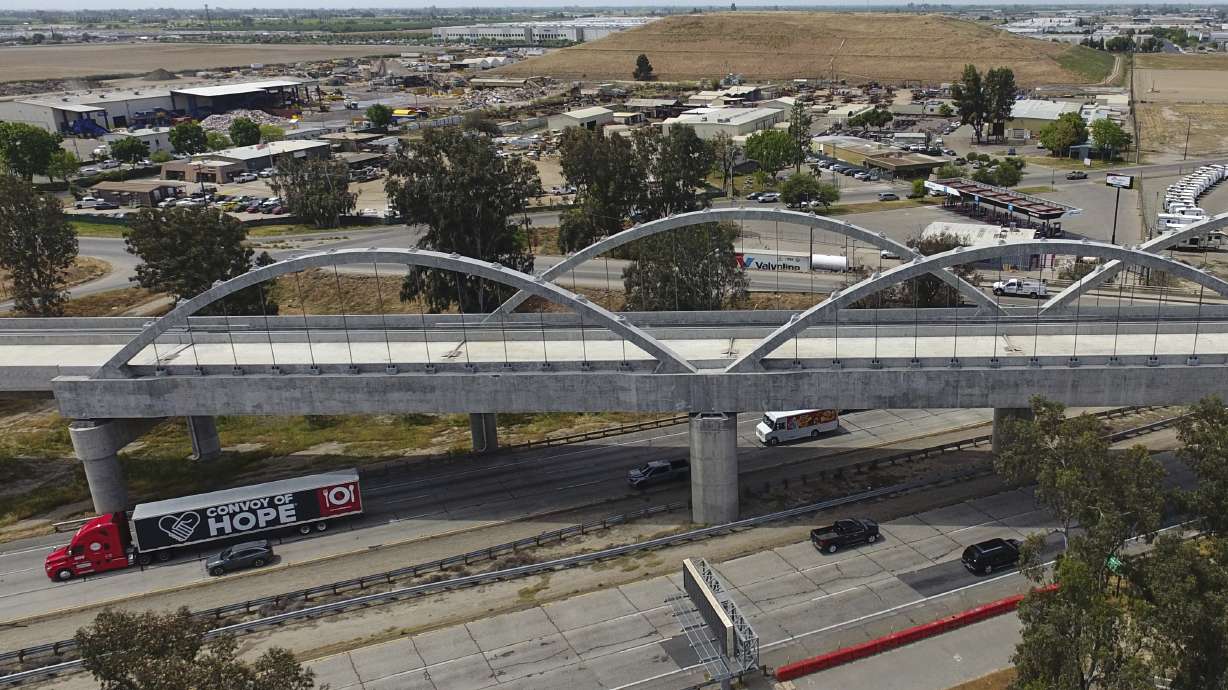 Vehicles pass underneath the Cedar Viaduct, designed to take high-speed trains over Cedar and North avenues and State Route 99, on April 15, in Fresno, Calif.
