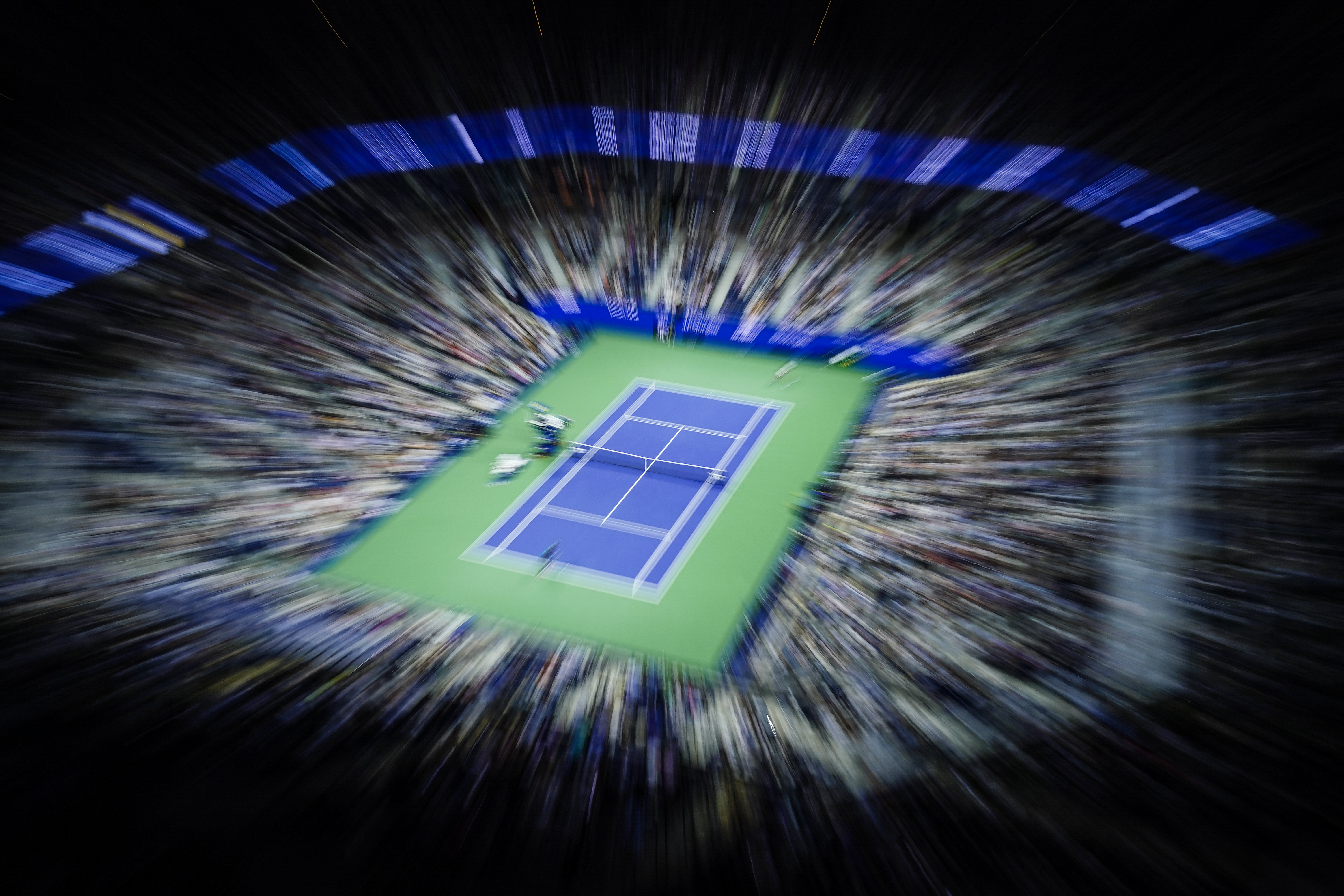 FILE - In this image made with a zoom lens and slow shutter speed, Frances Tiafoe, near side, of the United States, plays against Sebastian Ofner, of Austria, during the second round of the U.S. Open tennis tournament Wednesday, Aug. 30, 2023, at Arthur Ashe Stadium in New York.