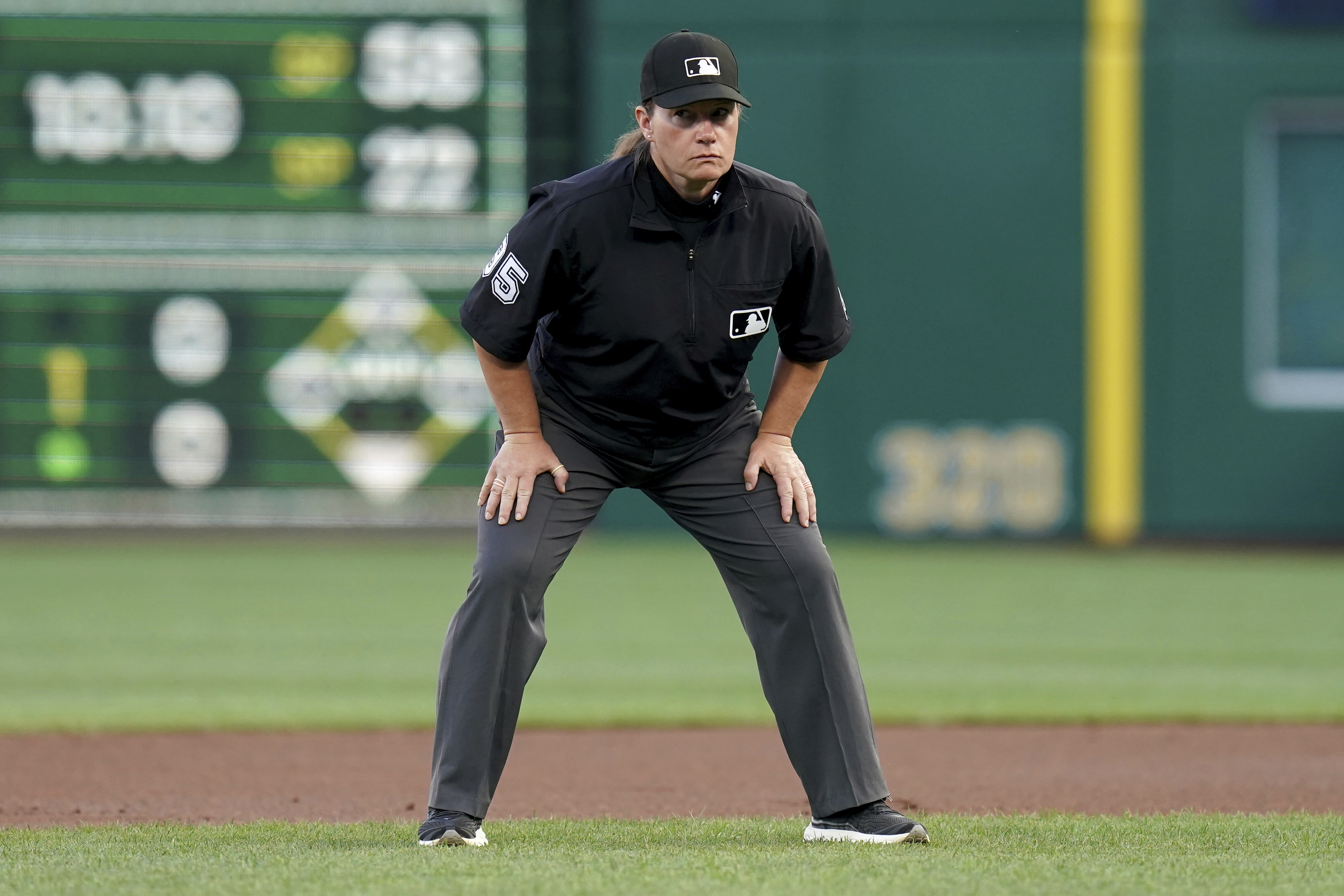 Umpire Jen Pawol watches during the first inning of a baseball game between the Colorado Rockies and the Pittsburgh Pirates, Friday, Aug. 22, 2025, in Pittsburgh. 