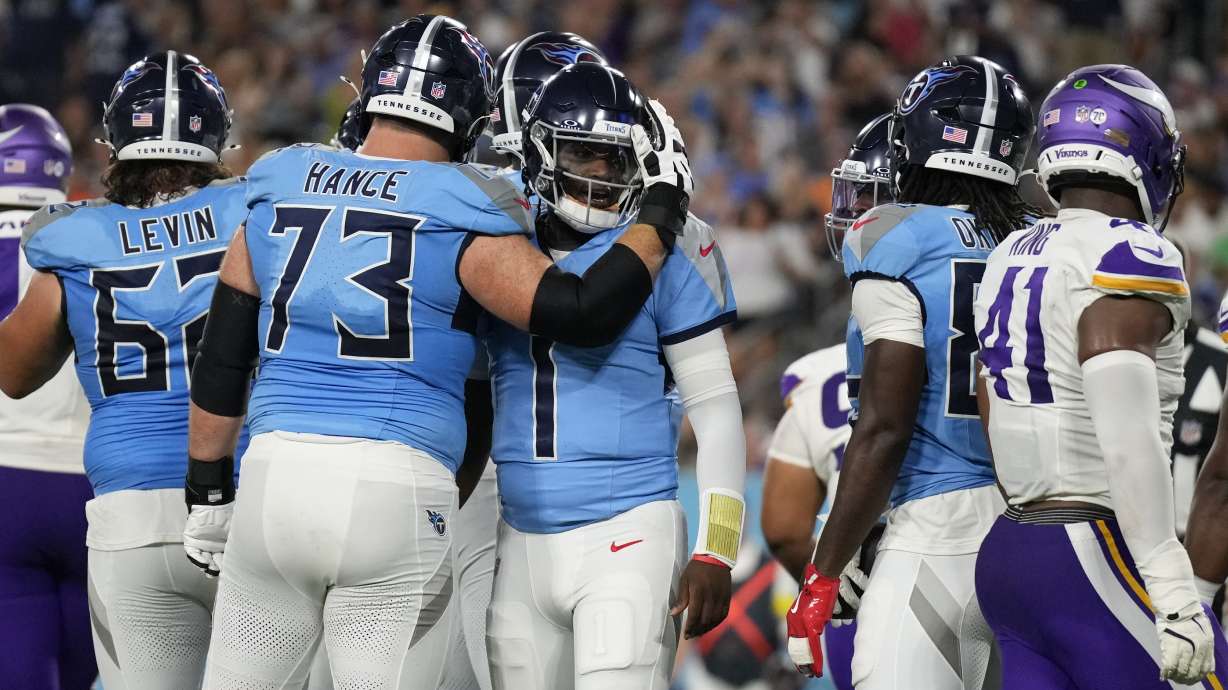 Tennessee Titans quarterback Cam Ward (1) celebrates with guard Blake Hance (73) after a touchdown by running back Julius Chestnut (36) during the first half of a preseason NFL football game against the Minnesota Vikings, Friday, Aug. 22, 2025, in Nashville, Tenn.