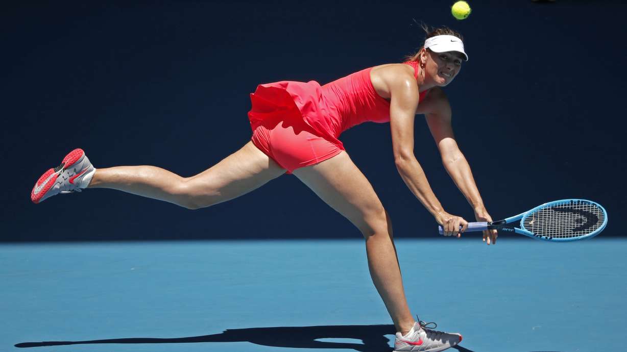FILE - Russia's Maria Sharapova makes a backhand return to Croatia's Donna Vekic during their first round singles match at the Australian Open tennis championship in Melbourne, Australia, Jan. 21, 2020.