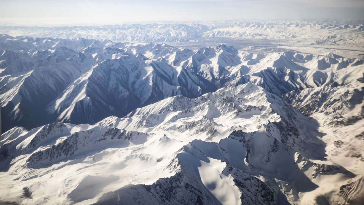 An aerial view taken from a commercial plane shows Tian Shan Range in Kyrgyzstan on April 29, 2021. Hopes are fading that an injured climber who has been stuck on a mountain in Kyrgyzstan for 12 days after rescue efforts had to be terminated because of bad weather.