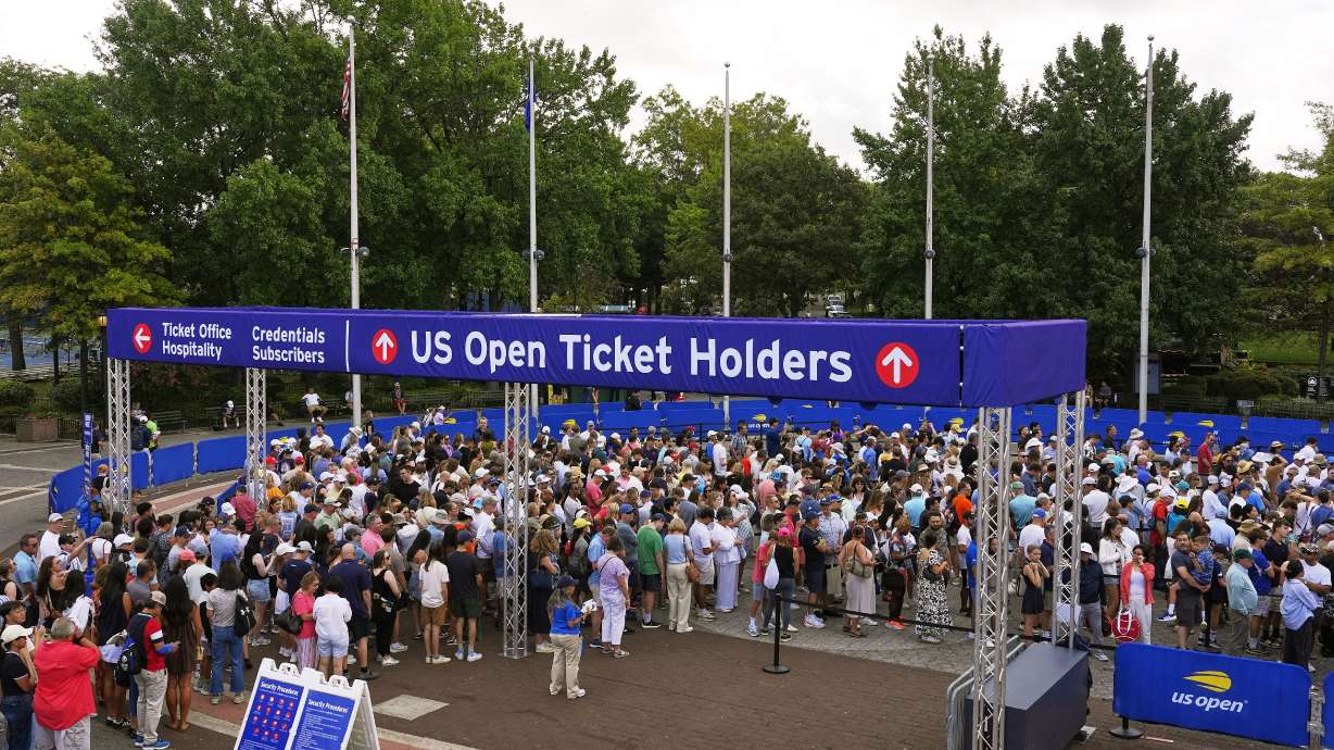 Spectators wait for gates to open at the Billie Jean King National Tennis Center for the first round of the US Open tennis championships, Sunday, Aug. 24, 2025, in New York.