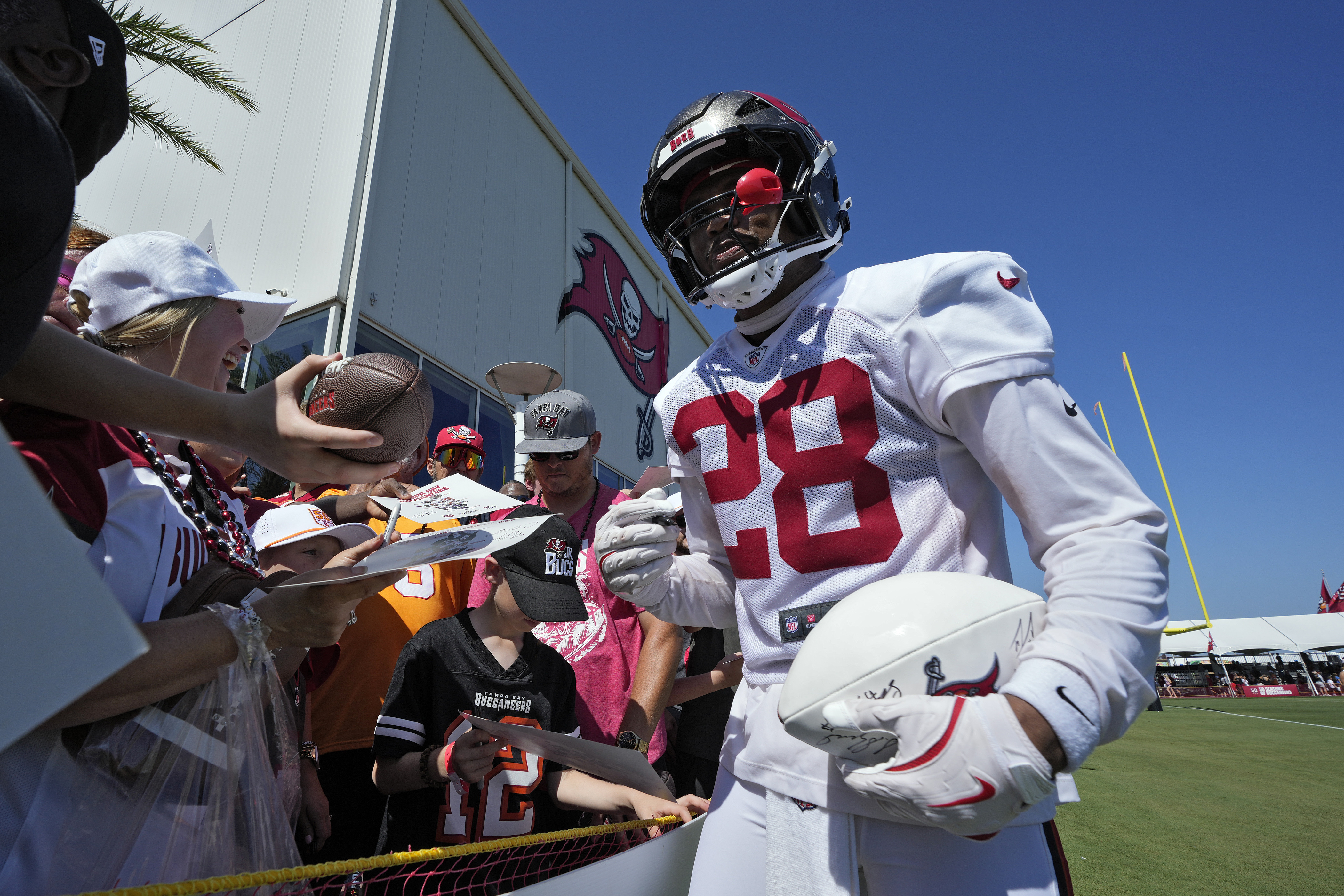 Tampa Bay Buccaneers safety Shilo Sanders signs autographs for fans during Back Together Weekend at an NFL football training camp practice Sunday, July 27, 2025, in Tampa, Fla. 
