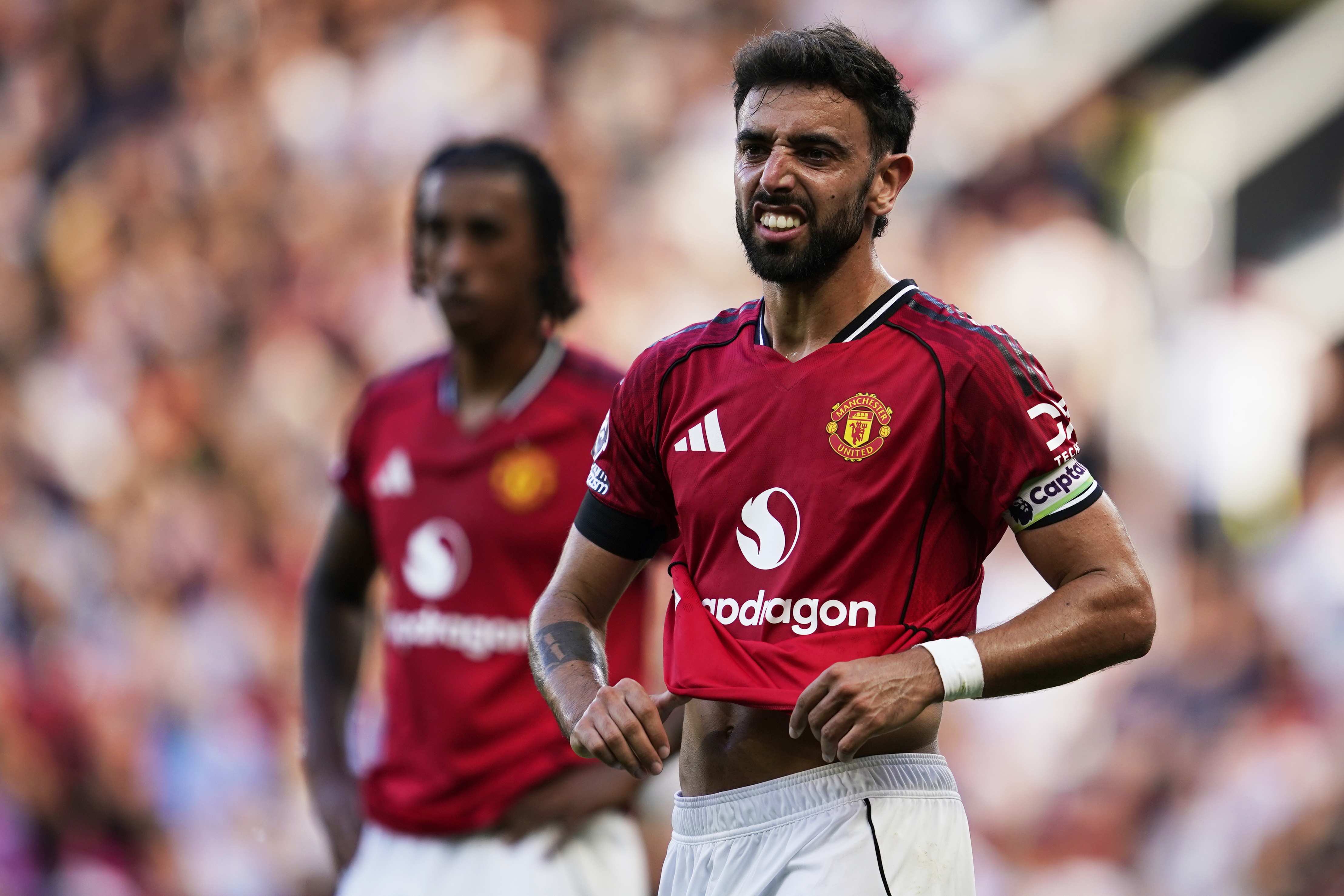 Manchester United's Bruno Fernandes grimaces during the English Premier League soccer match between Manchester United and Arsenal at Old Trafford stadium in Manchester, England, Sunday, Aug. 17, 2025. 