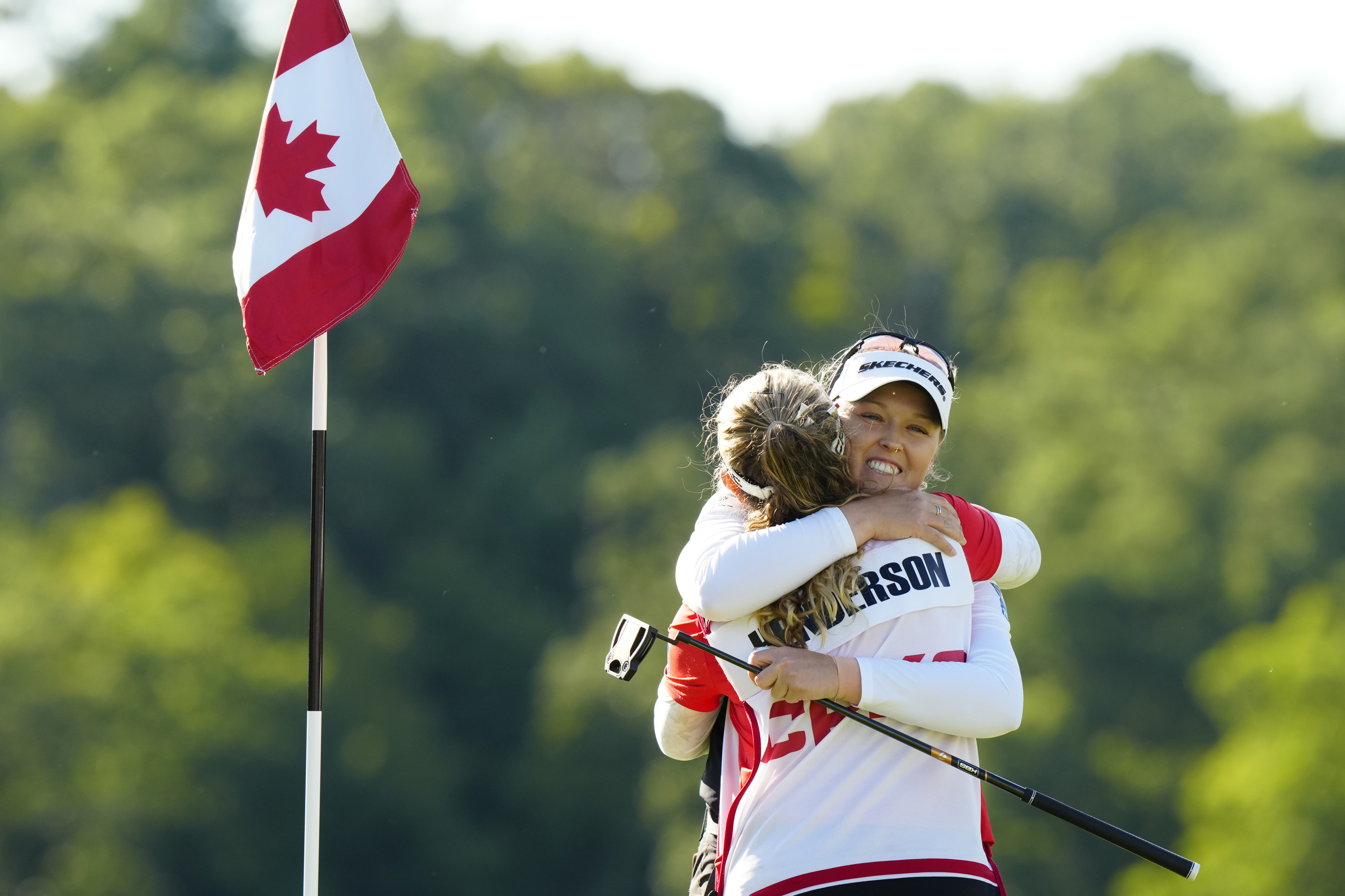 Brooke Henderson, right, of Canada, hugs her caddie, and sister, Brittany Henderson, left, after winning the Canadian Women's Open golf tourrnament on the 18th hole in Mississauga, Ontario, Sunday Aug. 24, 2025. 