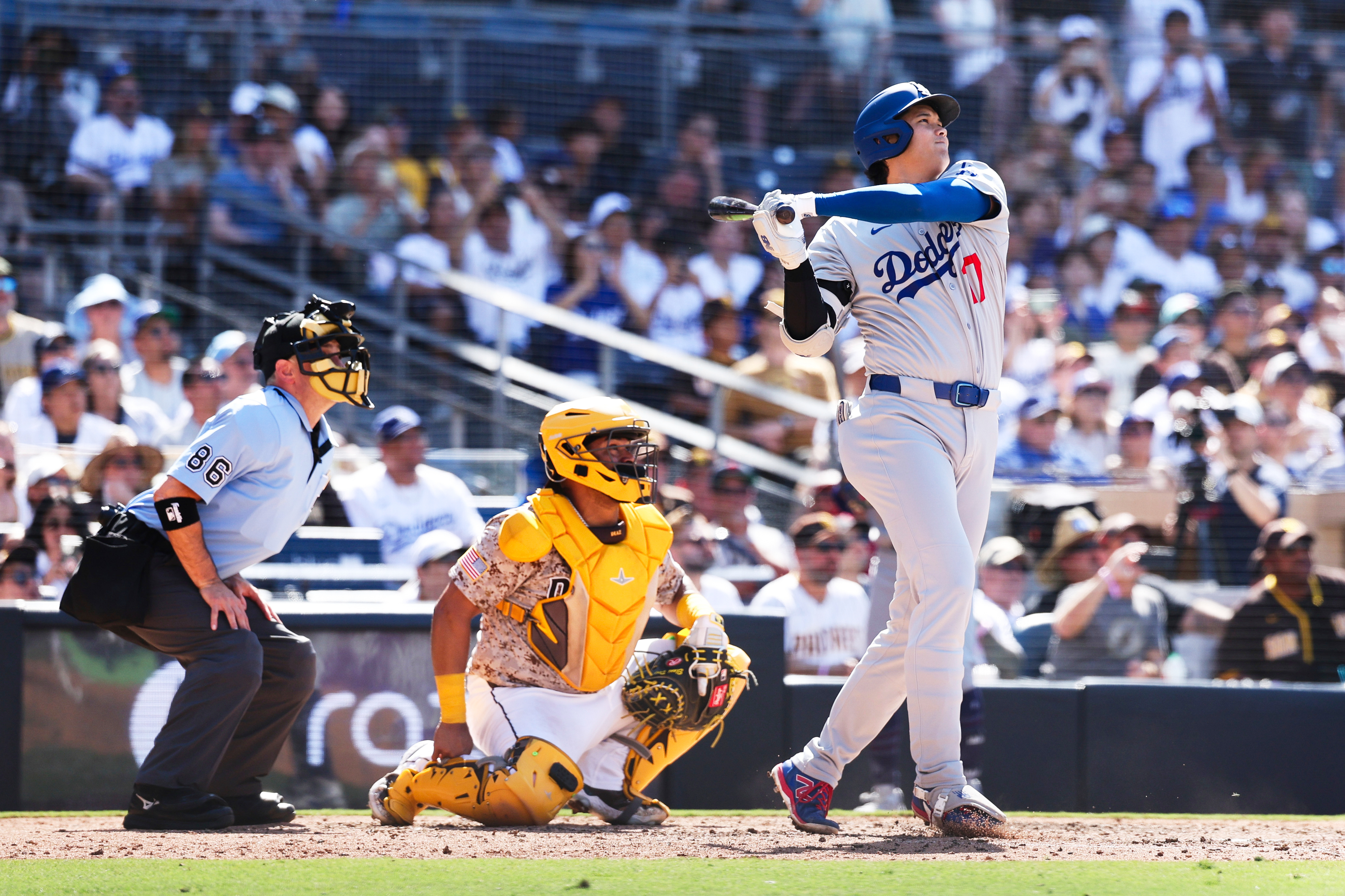 Los Angeles Dodgers' Shohei Ohtani hits a solo home run against the San Diego Padres in the ninth inning of a baseball game Sunday, Aug. 24, 2025, in San Diego. 