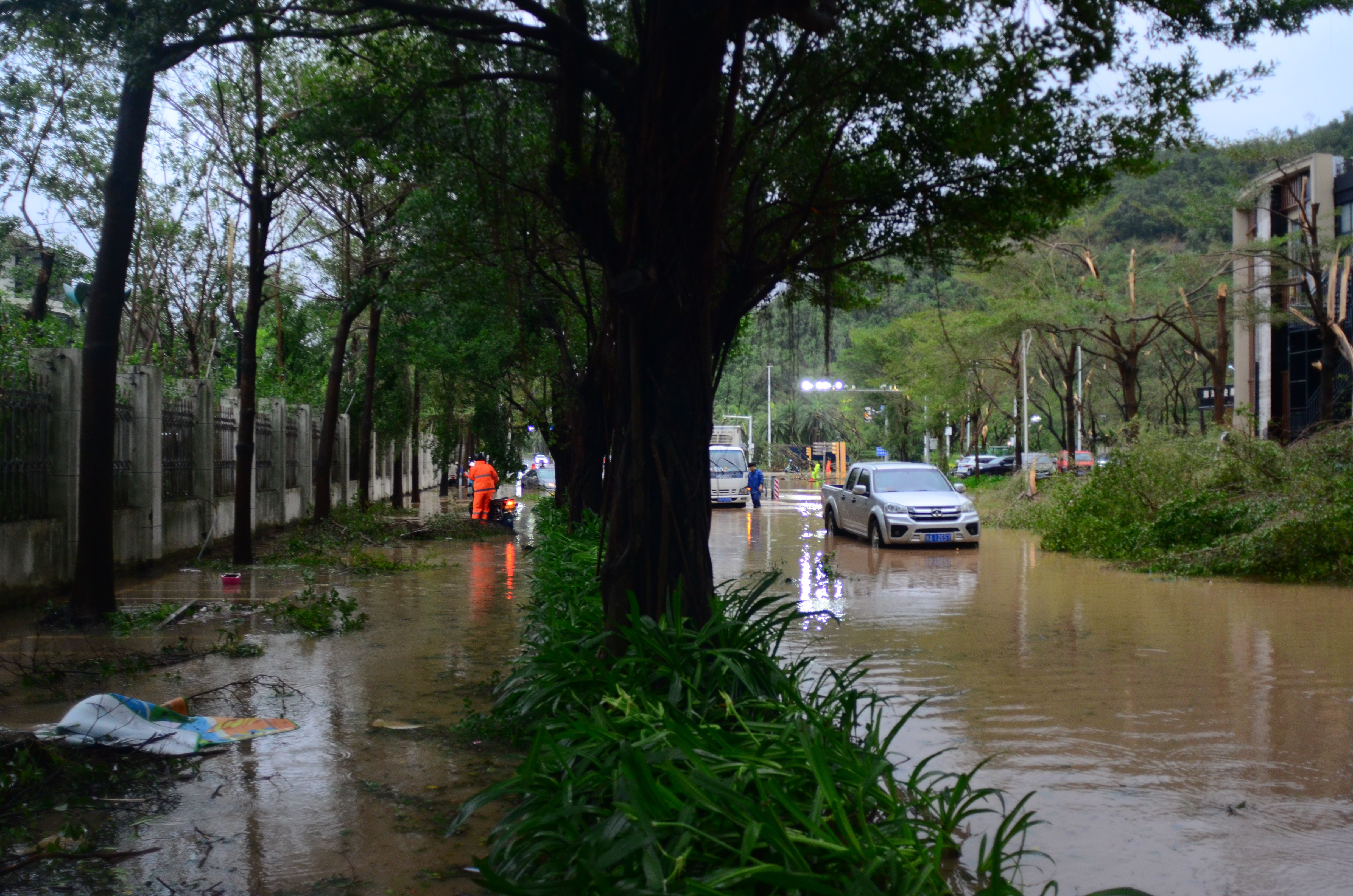 A car drives on a flooded street as Typhoon Kajiki brings strong winds and heavy rain on Monday in Sanya, Hainan Province of China.