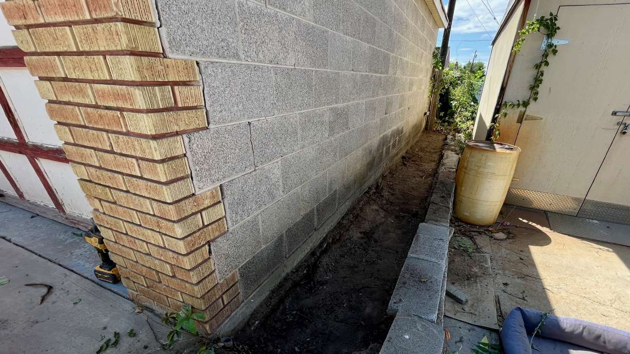 Landscapers found explosive materials on Monday buried in this narrow strip of land beside the garage of a Washington Terrace home. Authorities safely removed them.