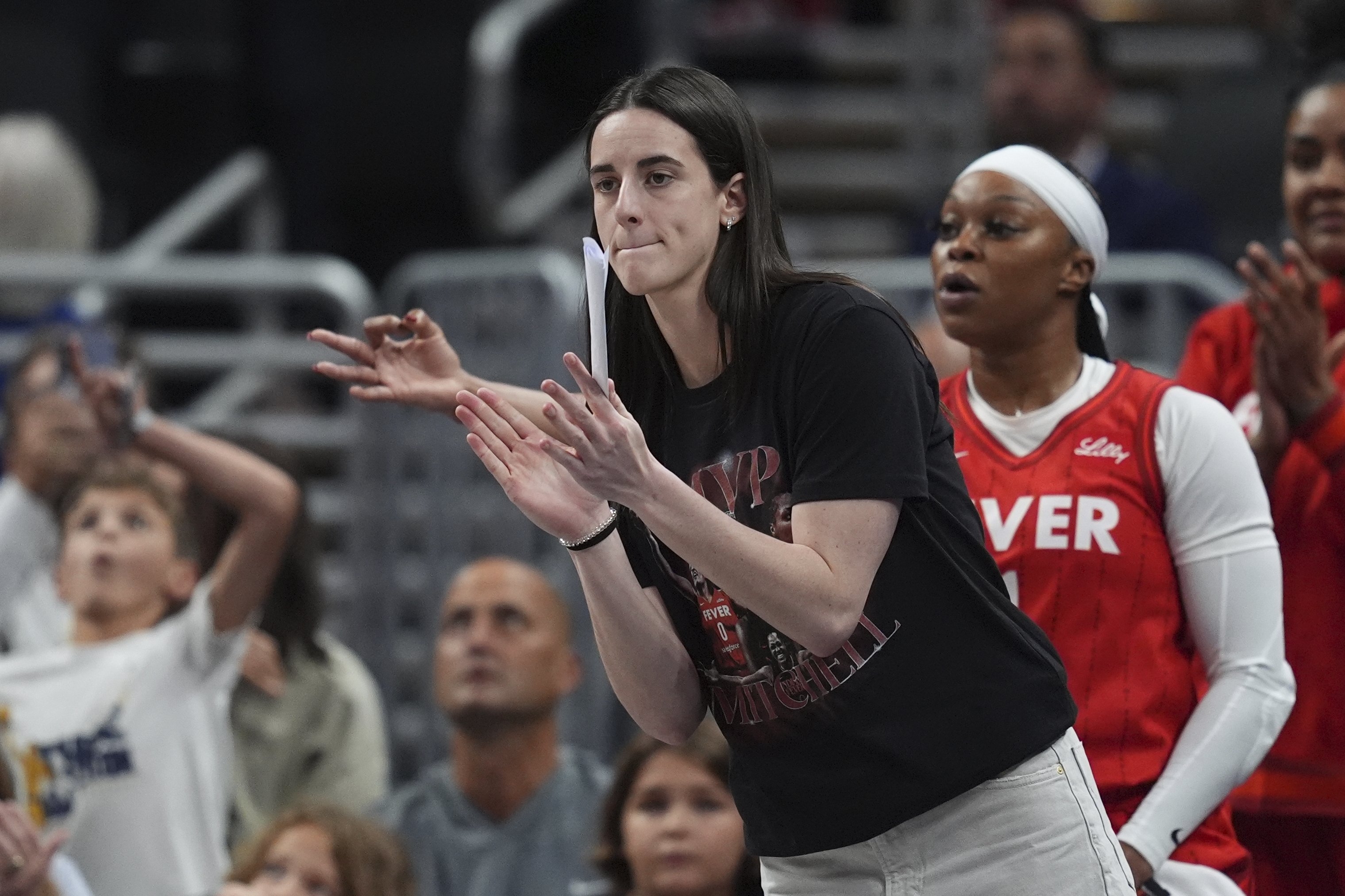 Indiana Fever's Caitlin Clark cheers during the first half of a WNBA basketball game against the Minnesota Lynx, Friday, Aug. 22, 2025, in Indianapolis.