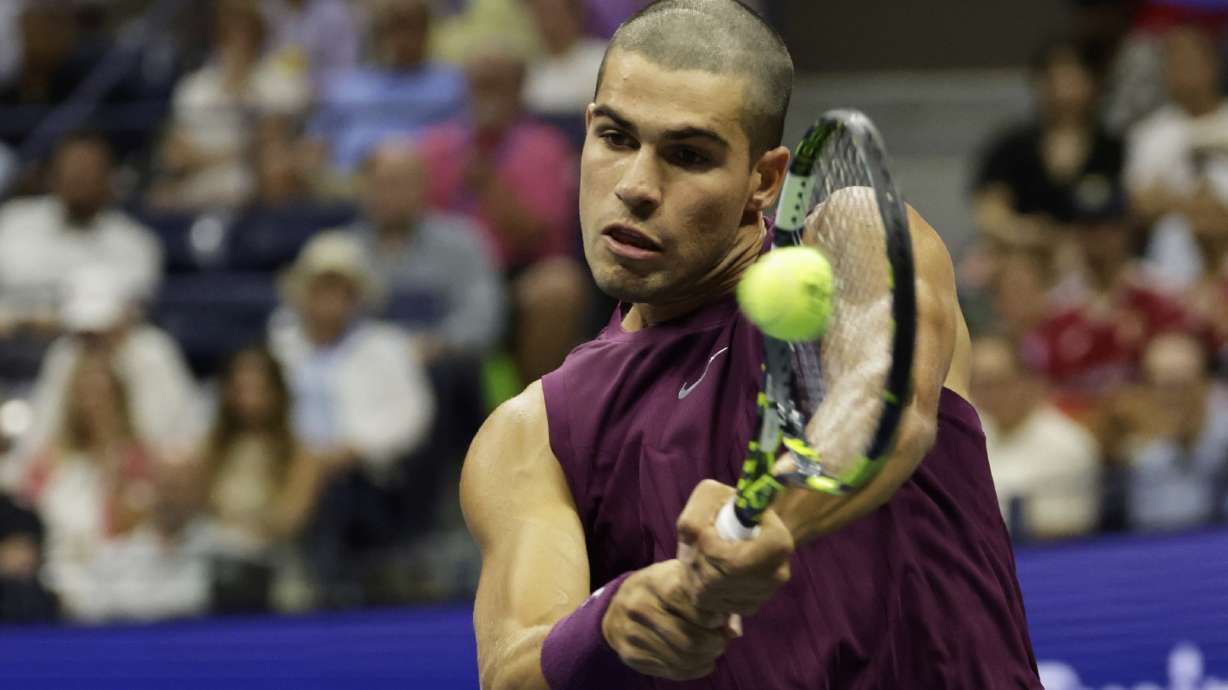 Carlos Alcaraz, of Spain, returns a shot to Reilly Opelka, of the United States, during the first round of the U.S. Open tennis championships, Monday, Aug. 25, 2025, in New York.