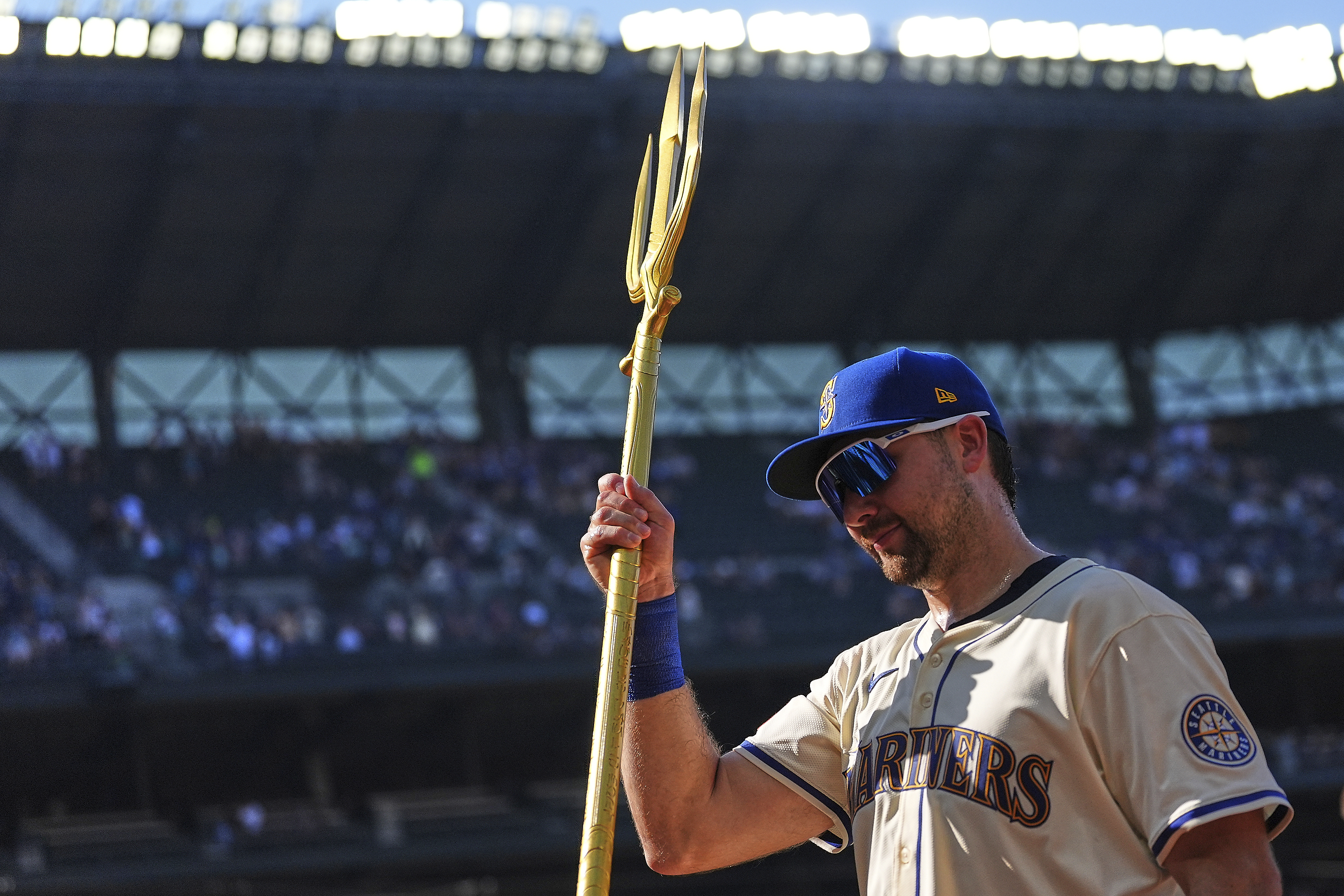 Seattle Mariners catcher Cal Raleigh lifts the trident to celebrate a win over the Athletics in a baseball game Sunday, Aug. 24, 2025, in Seattle. 
