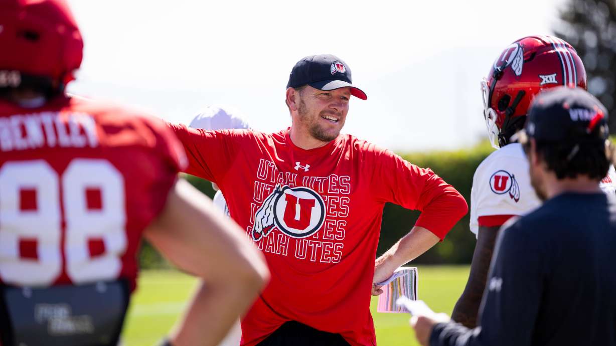 Utah offensive coordinator Jason Beck talks to a player during the team's fall camp in Salt Lake City on August 6, 2025.