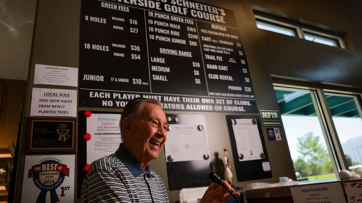 Ernie Schneiter Jr., who is 95, talks with patrons at Schneiter's Riverside Golf in Ogden on Aug. 11. Schneiter has been the head professional at the course he designed for 56 years.