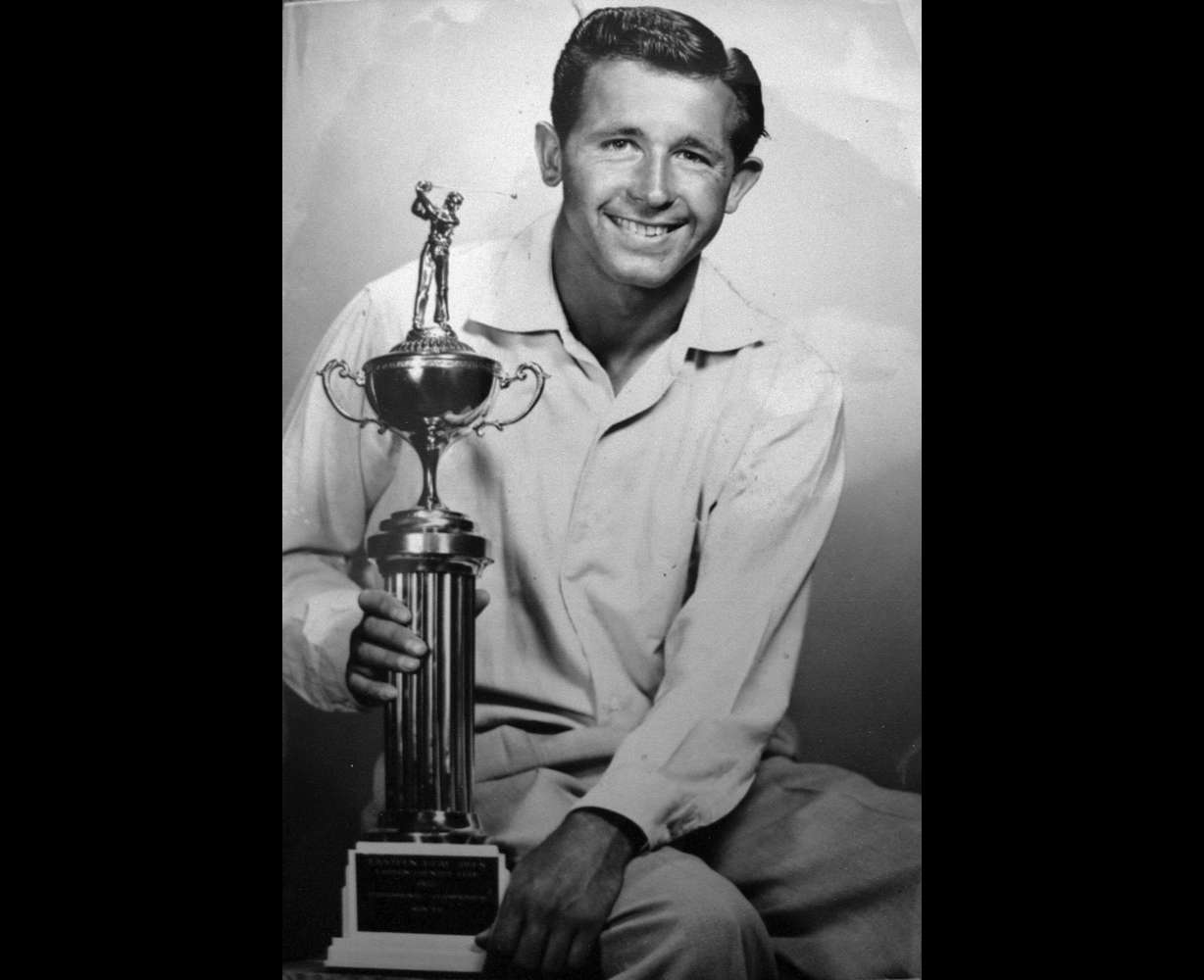 Ernie Schneiter Jr. is pictured in this 1957 photograph with one of many trophies he won over his long golf career. Schneiter won his first Utah Junior Open in 1945, leading him to fall in love with the game of golf.