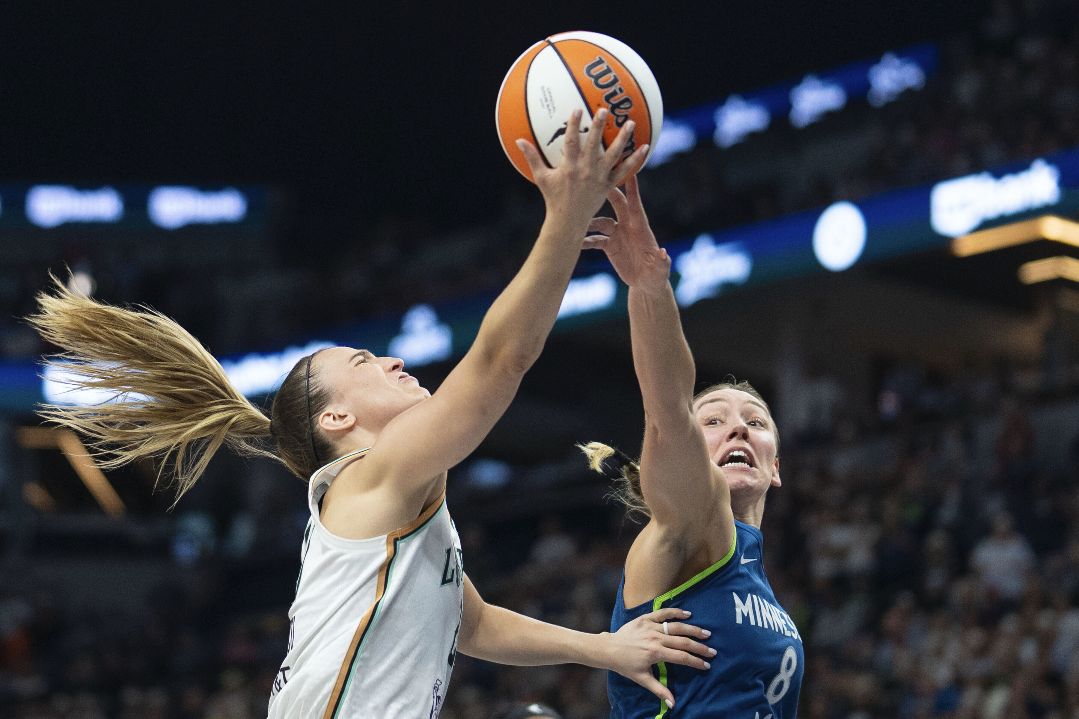 Minnesota Lynx forward Alanna Smith (8) blocks a lay-up attempt by New York Liberty guard Sabrina Ionescu (20) late in the fourth quarter of a WNBA basketball game Saturday, Aug. 16, 2025, in Minneapolis.