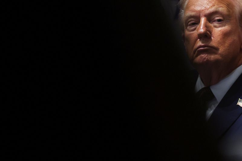 President Donald Trump holds a cabinet meeting at the White House Tuesday. A lawyer for Federal Reserve Gov. Lisa Cook said she would sue Trump to prevent her firing.