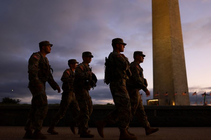 Members of the National Guard walk at the National Mall after President Donald Trump deployed National Guard troops and ordered an increased presence of federal law enforcement to assist in crime prevention, in Washington, D.C., Thursday.
