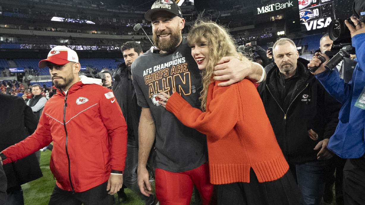 FILE - Kansas City Chiefs tight end Travis Kelce and Taylor Swift walk together after an AFC Championship NFL football game between the Chiefs and the Baltimore Ravens, Jan. 28, 2024, in Baltimore.