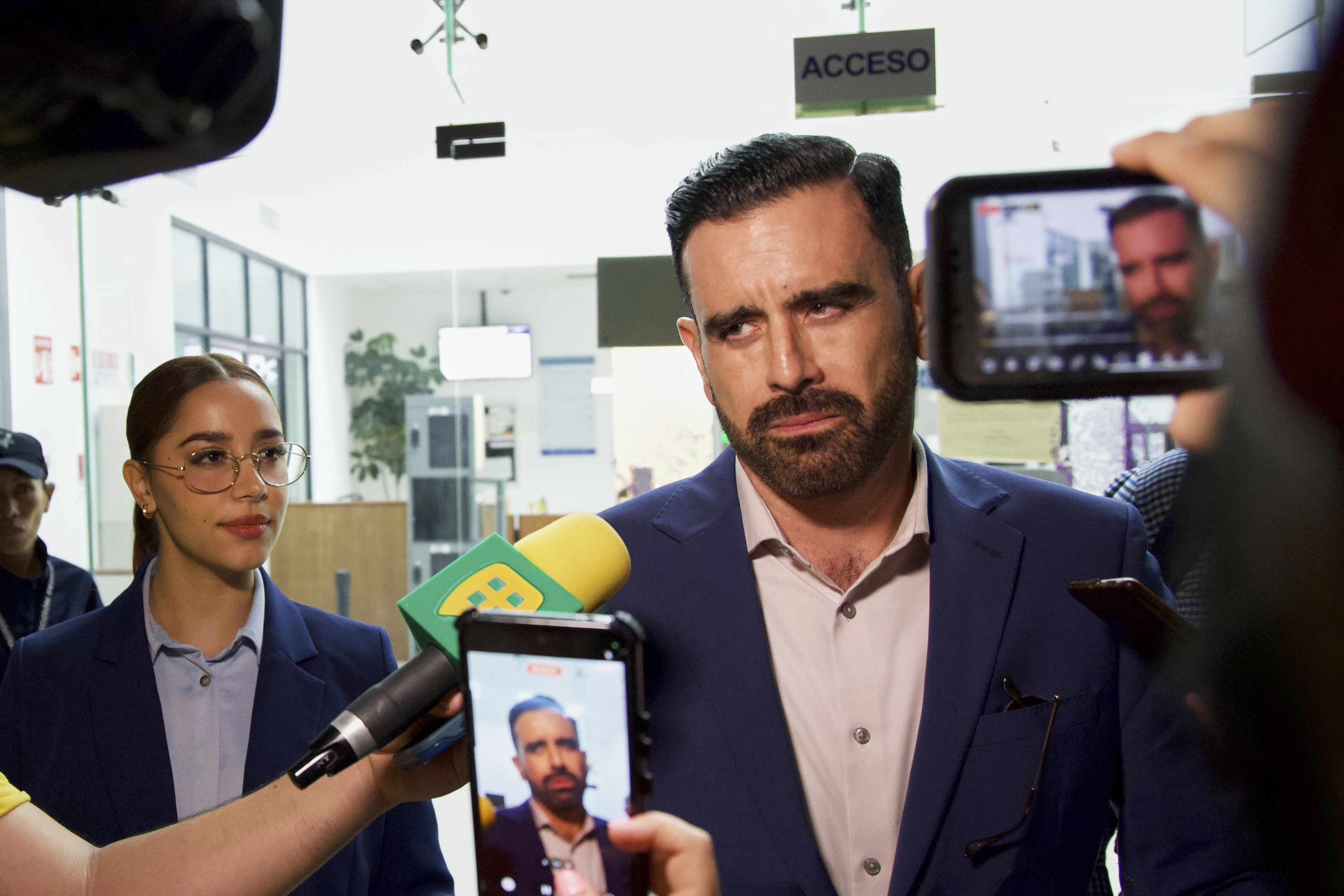 Alejandra Payan, left, and Ruben Benitez, right, lawyers for boxer Julio César Chávez Jr., speak to the press after the hearing to determine his legal status in Hermosillo, Mexico, Saturday, Aug. 23, 2025. 