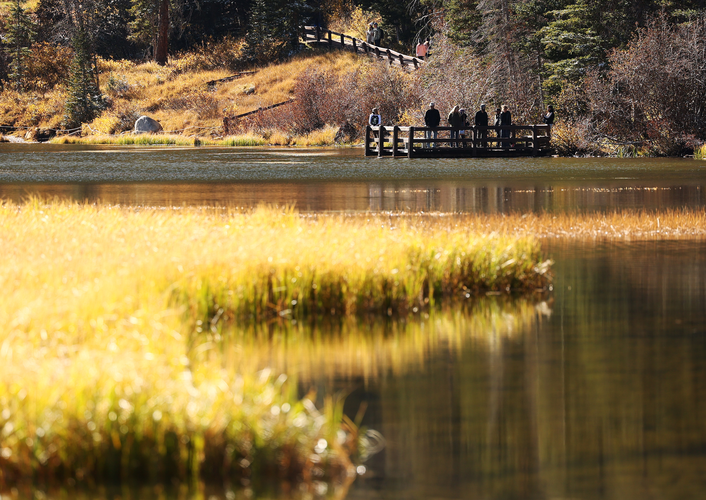 Sunlight and a light dusting of snow as hikers walk around Silver Lake in Big Cottonwood Canyon on Oct. 11, 2020.