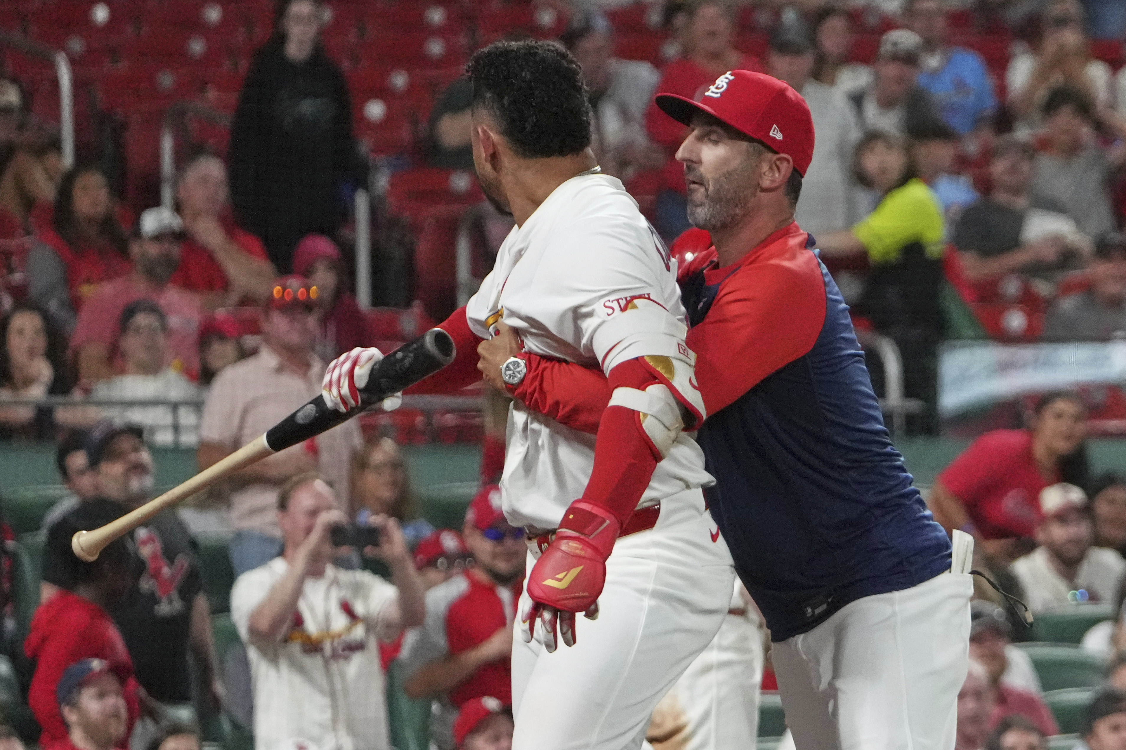 St. Louis Cardinals' Willson Contreras, left, is held back by Cardinals bench coach Daniel Descalso after being ejected during the seventh inning of a baseball game against the Pittsburgh Pirates Monday, Aug. 25, 2025, in St. Louis.