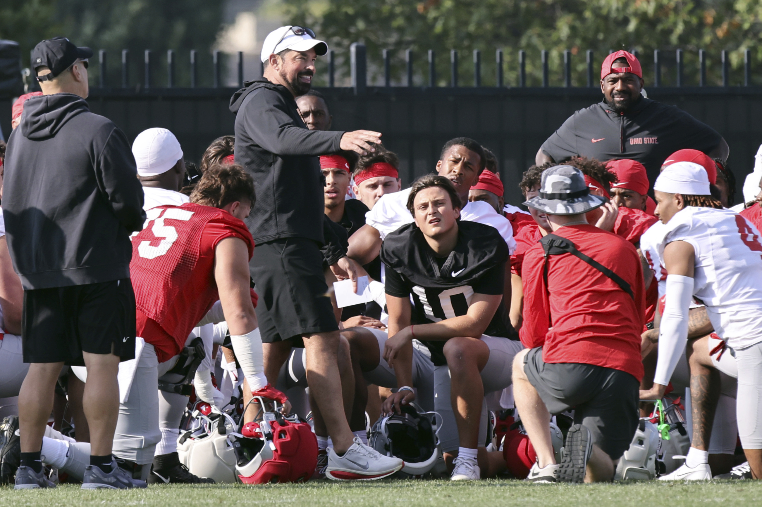 Ohio State coach Ryan Day talks to his team during NCAA college football practice in Columbus, Ohio, Friday, Aug. 1, 2025. 