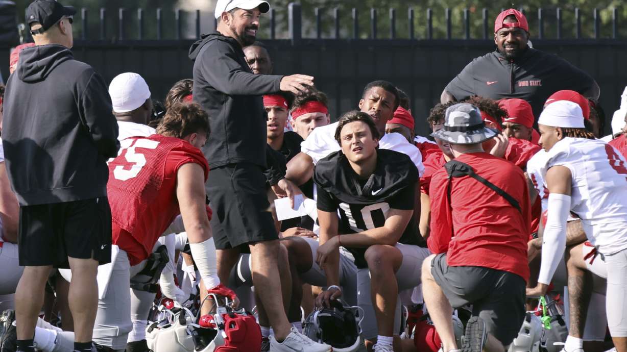Ohio State coach Ryan Day talks to his team during NCAA college football practice in Columbus, Ohio, Friday, Aug. 1, 2025.