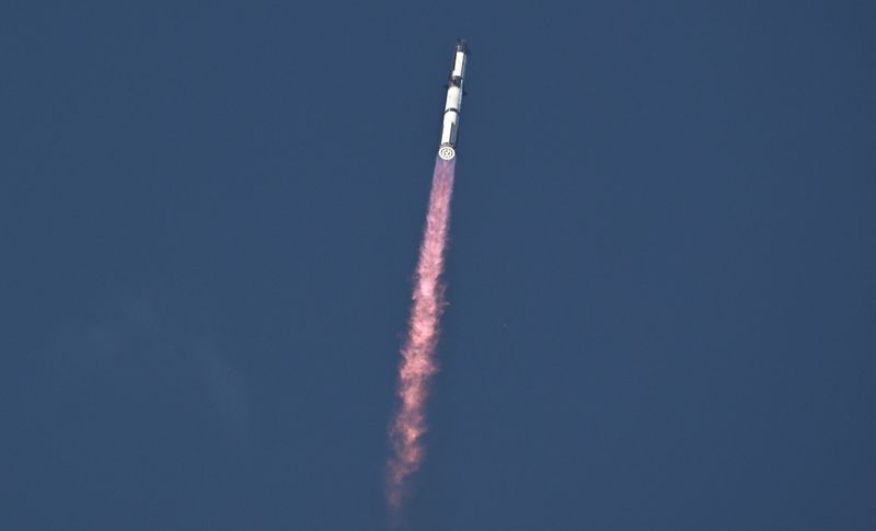 A SpaceX Super Heavy booster carrying the Starship spacecraft lifts off in Starbase, Texas, Tuesday. The spacecraft dispersed its first batch of mock Starlink satellites in a major milestone for the program.