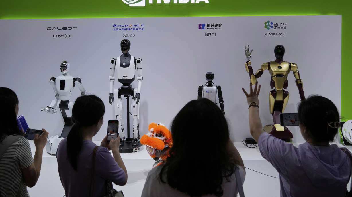 Visitors give commands to a robot at Nvidia's booth at the China International Exhibition Center, in Beijing, July 18. While the company's AI chip sales surged again, worries that the AI craze is fading continue to grow.