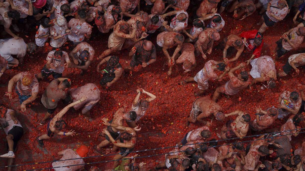 Revelers throw tomatoes at each other during the annual "Tomatina" tomato fight fiesta, in the village of Bunol near Valencia, Spain, Wednesday.