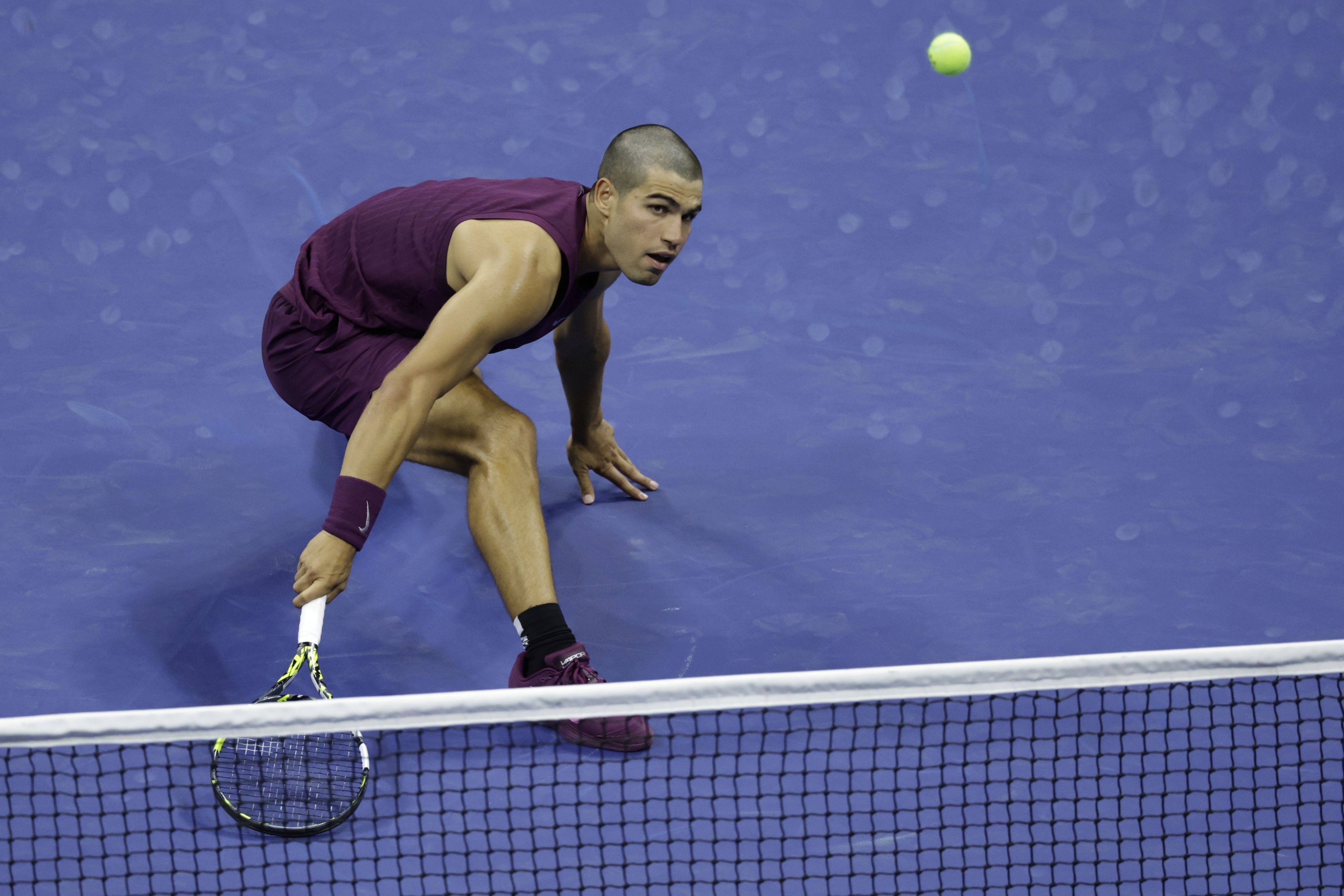 Carlos Alcaraz, of Spain, returns a shot to Reilly Opelka, of the United States, during the first round of the U.S. Open tennis championships, Monday, Aug. 25, 2025, in New York. 