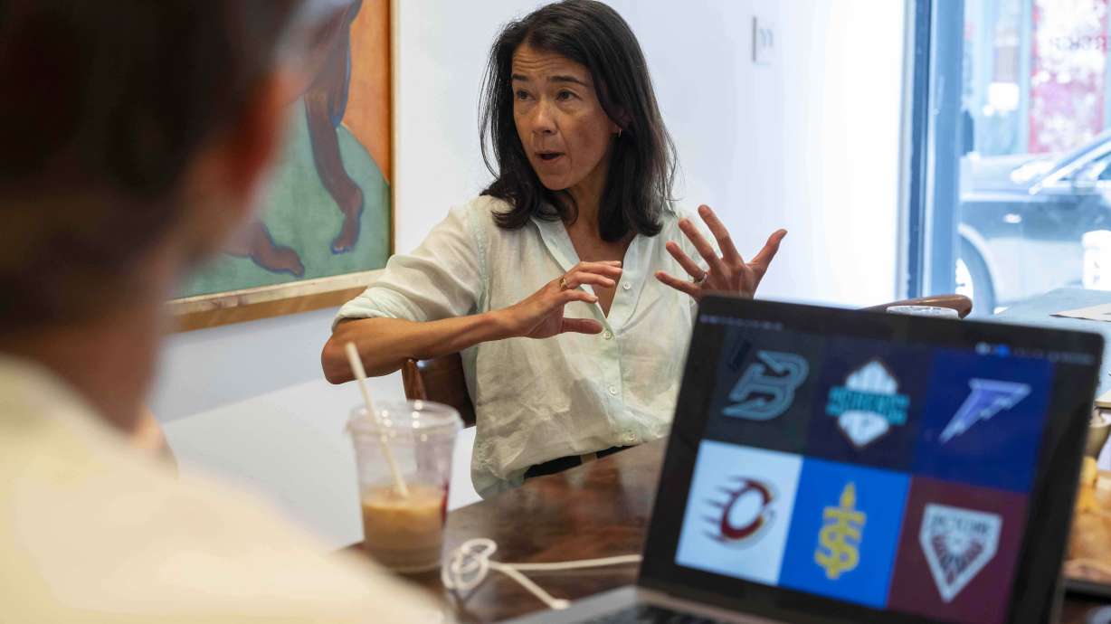 Flower Shop's co-founder and Chief Executive Officer Mary Lou Bunn speaks as sketches of team logos for Professional Women's Hockey League are shown on a computer screen, Thursday, July 30, 2025, in New York.