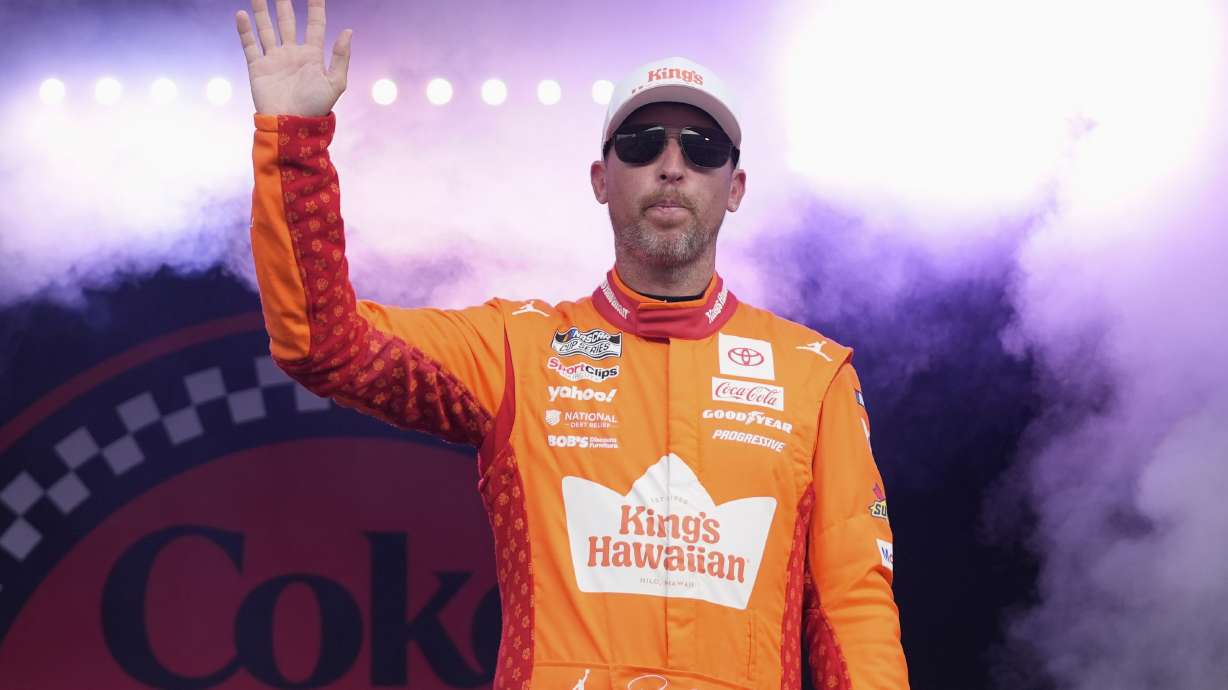 Denny Hamlin waves to fans during driver introductions before the NASCAR Cup Series auto race at Daytona International Speedway, Aug. 23, 2025, in Daytona Beach, Fla.