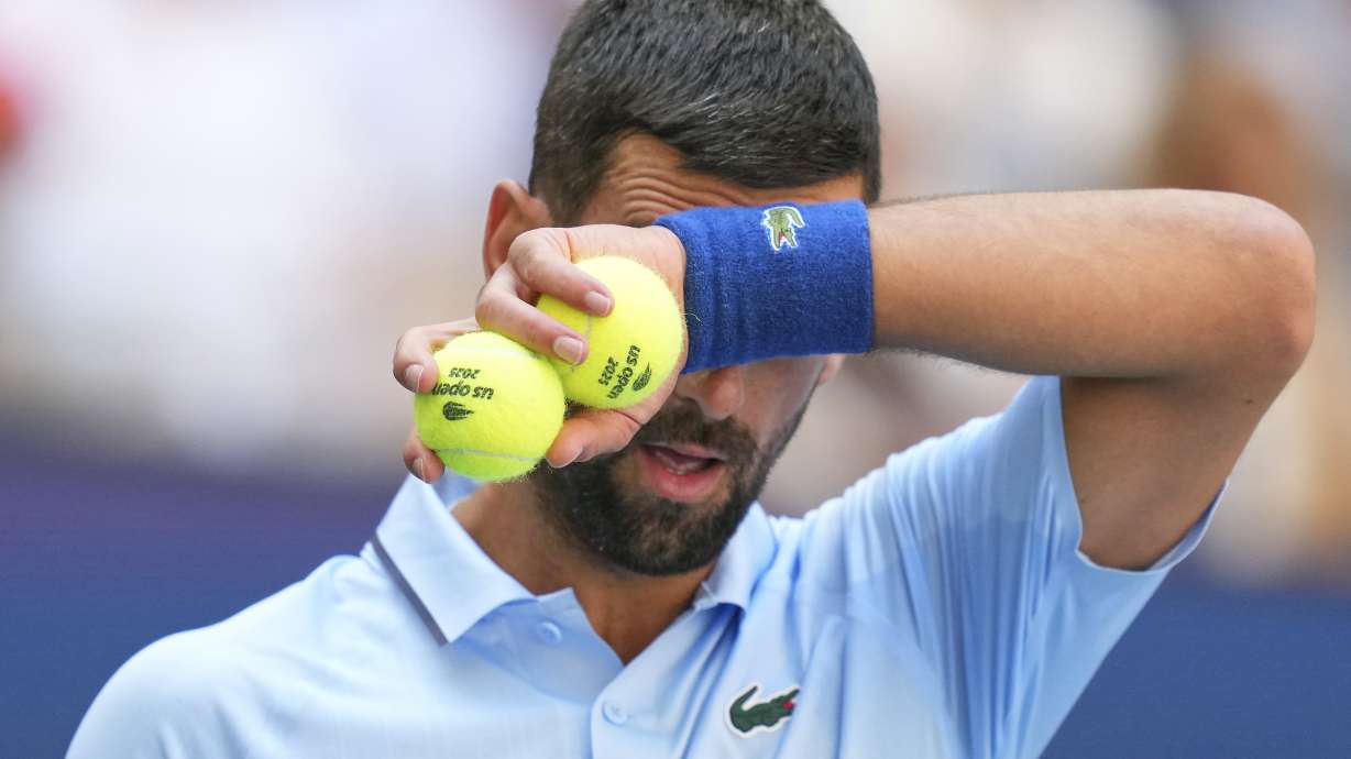 Novak Djokovic, of Serbia, wipes sweat from his face between serves to Zachary Svajda, of the United States, during the second round of the U.S. Open tennis championships, Wednesday, Aug. 27, 2025, in New York.