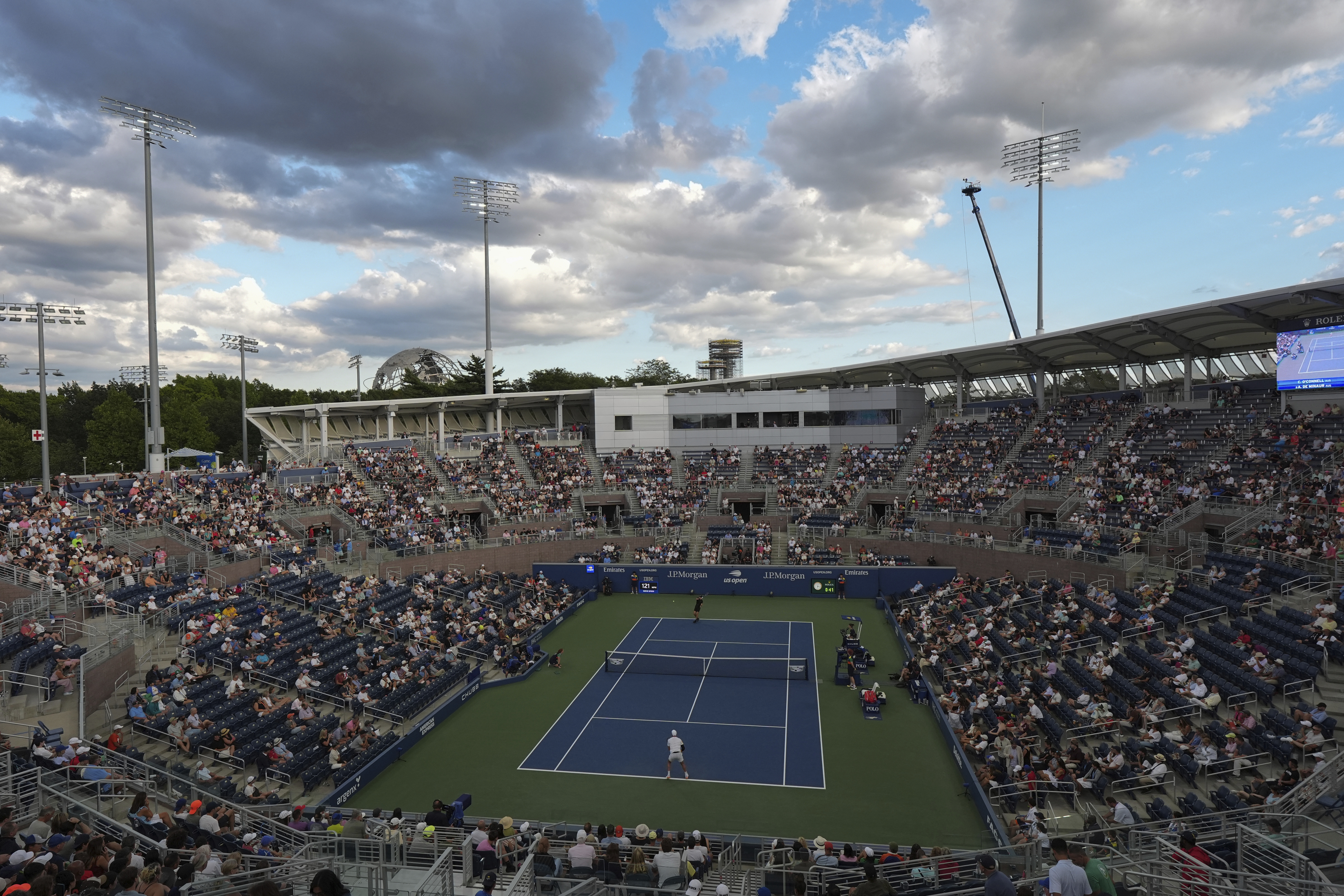 Alex de Minaur, of Australia, top in black, serves to Christopher O'Connell, of Australia, during the first round of the U.S. Open tennis championships, Tuesday, Aug. 26, 2025, in New York. 