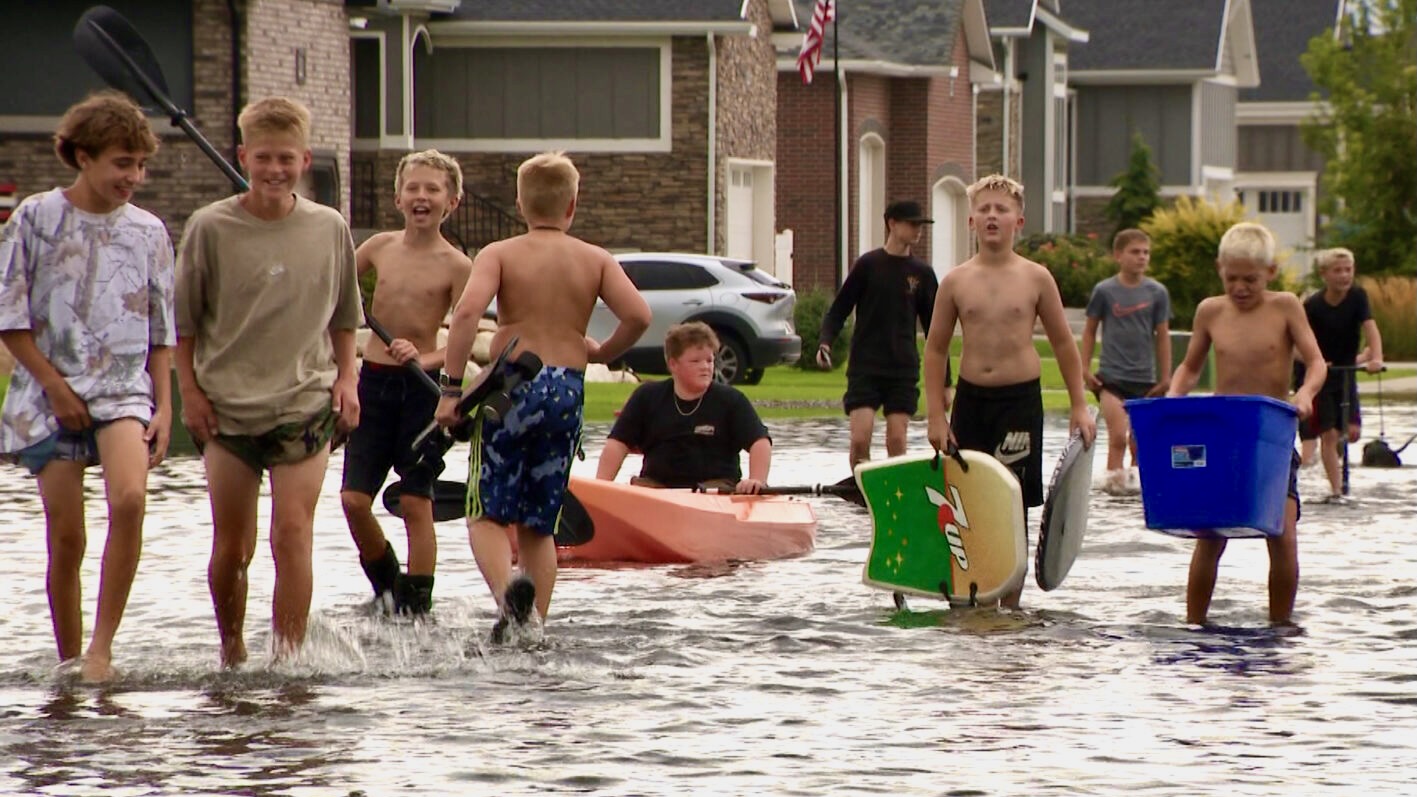 Heavy rain caused flooding in some streets in Farr West, Weber County, on Wednesday, prompting some kids to grab paddle boards to take advantage of the precipitation.