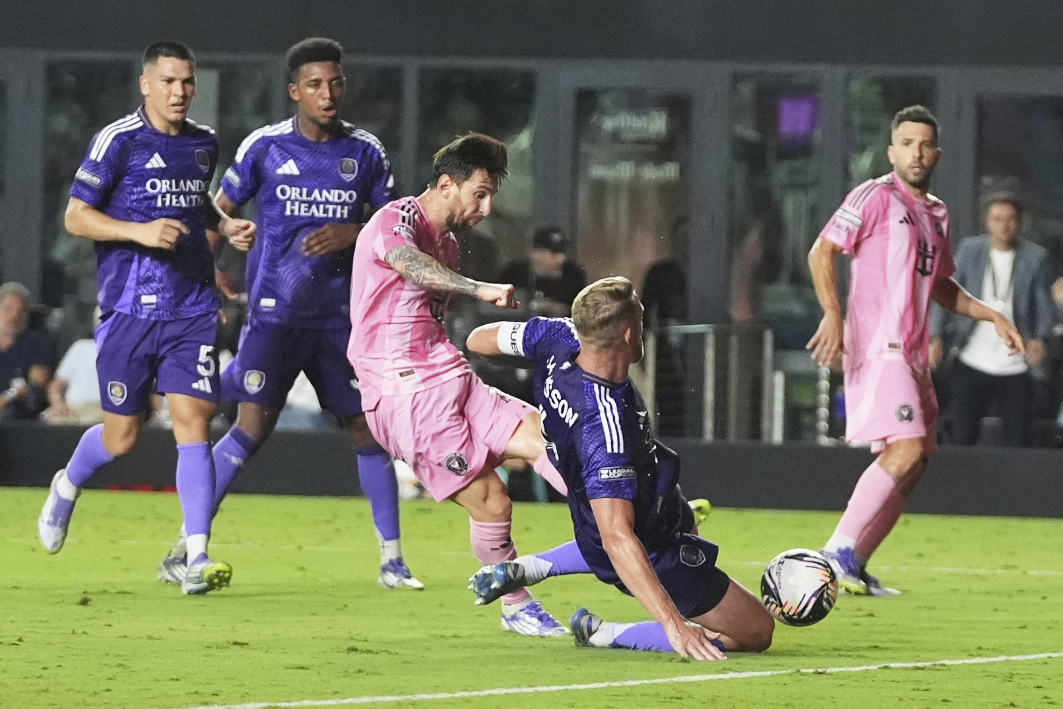 Inter Miami forward Lionel Messi, third from left, scores a goal as Orlando City defender Robin Jansson, second from right, defends during the second half of a Leagues Cup semifinal soccer match, Wednesday, Aug. 27, 2025, in Fort Lauderdale, Fla. 