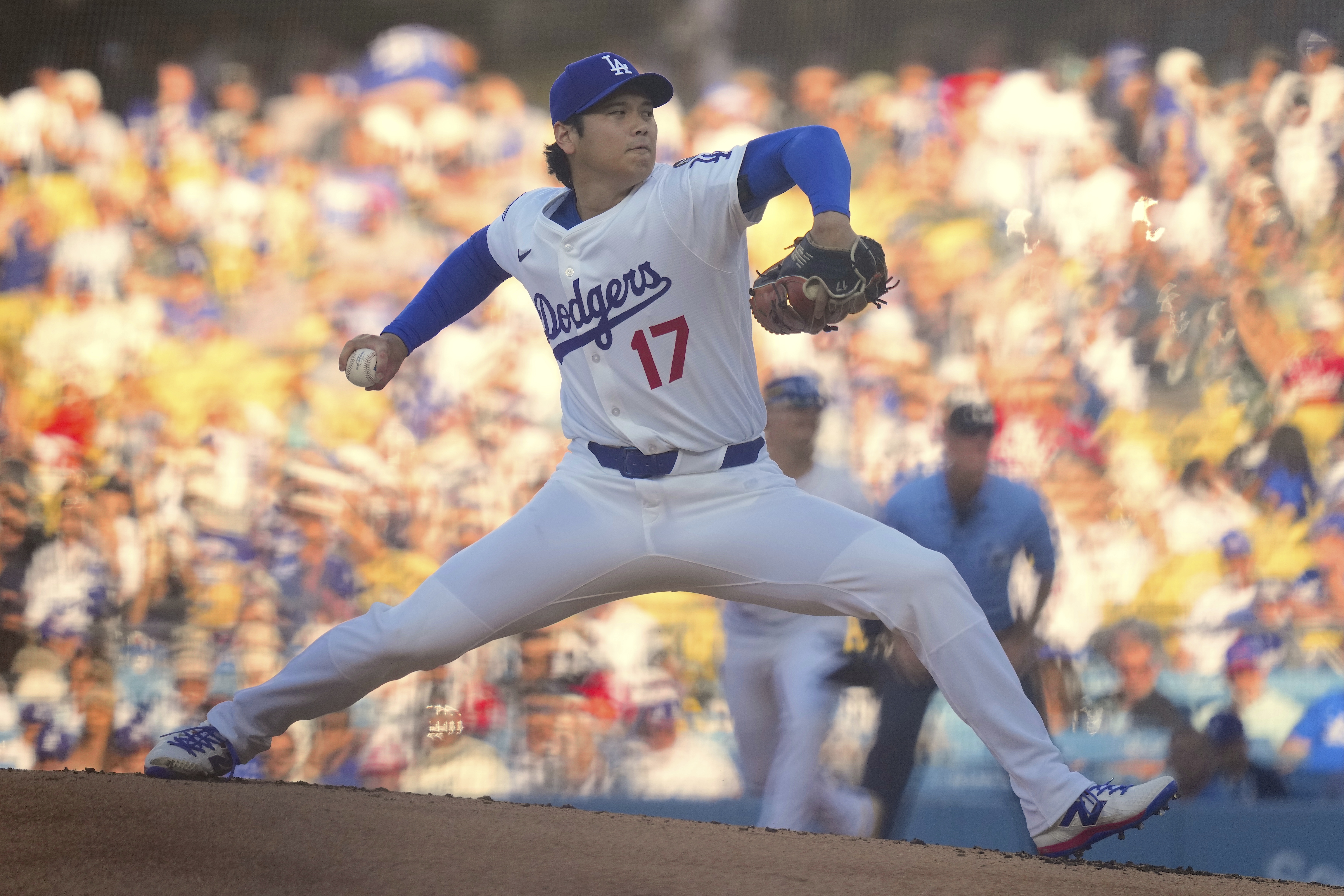 Los Angeles Dodgers designated hitter Shohei Ohtani throws to the plate during the first inning of a baseball game against the Cincinnati Reds, Wednesday, Aug. 27, 2025, in Los Angeles.